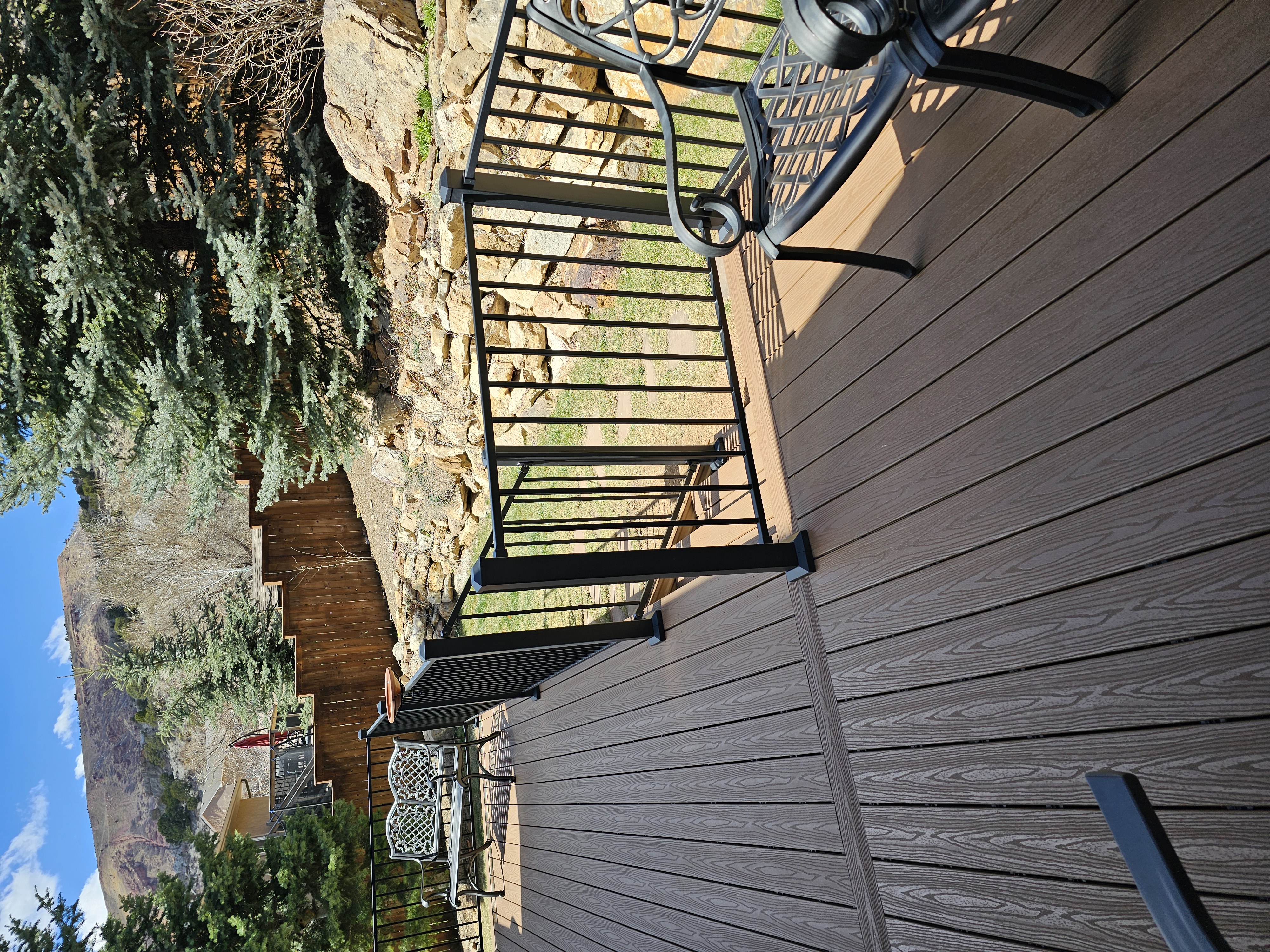 Stained wood deck with post-cap lighting at dusk