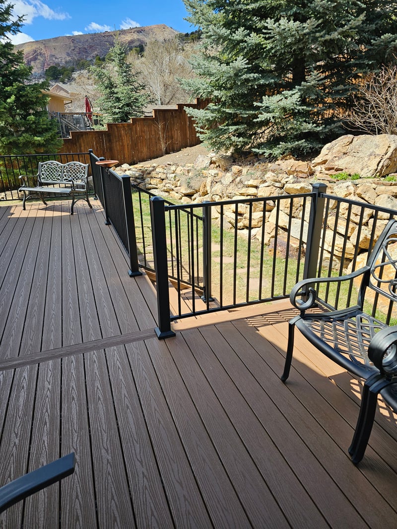 Stained wood deck with post-cap lighting at dusk