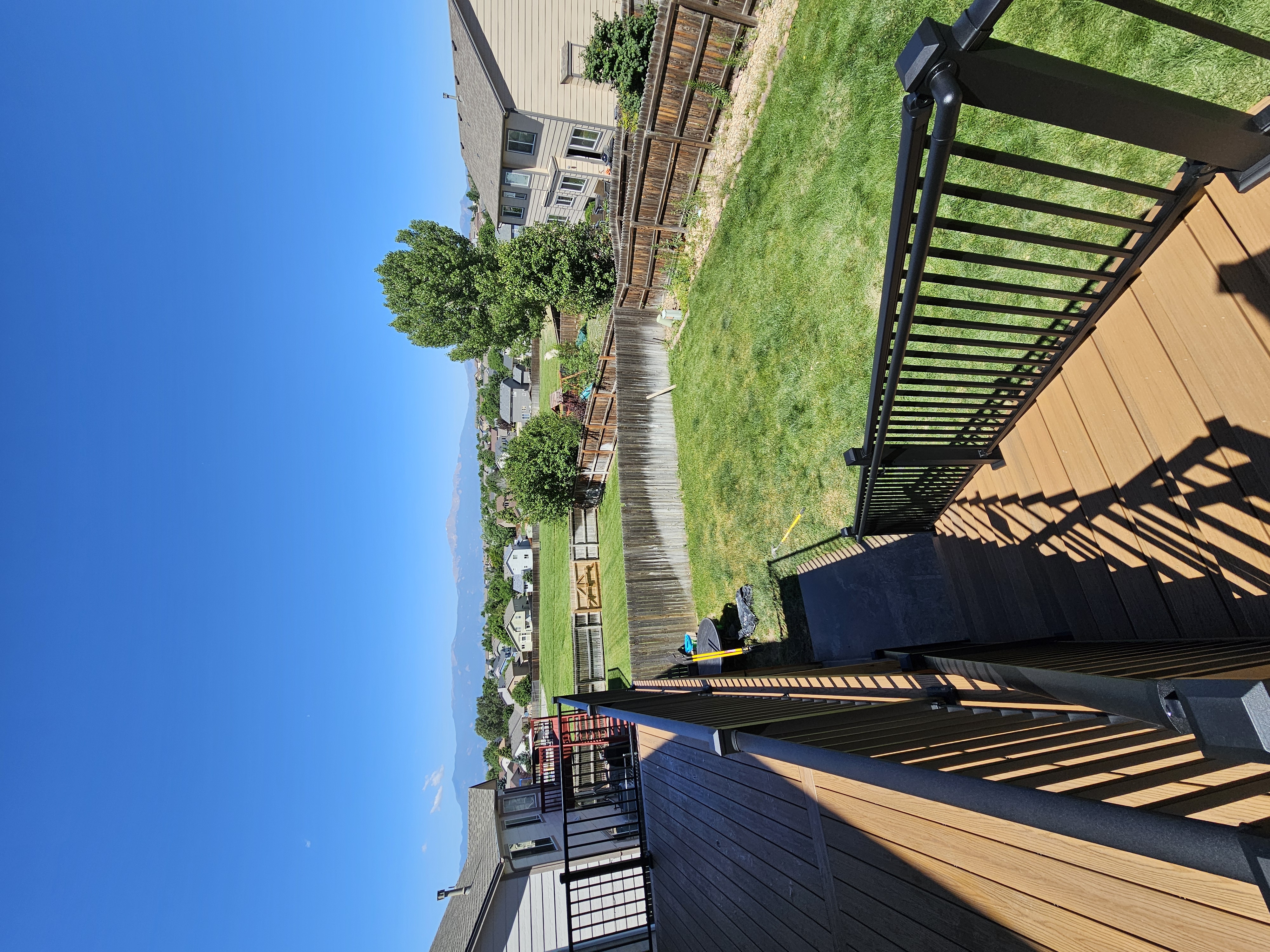 Low-profile ground-level deck with wide plank composite boards