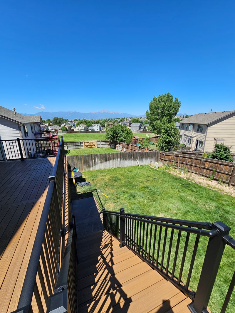 Low-profile ground-level deck with wide plank composite boards