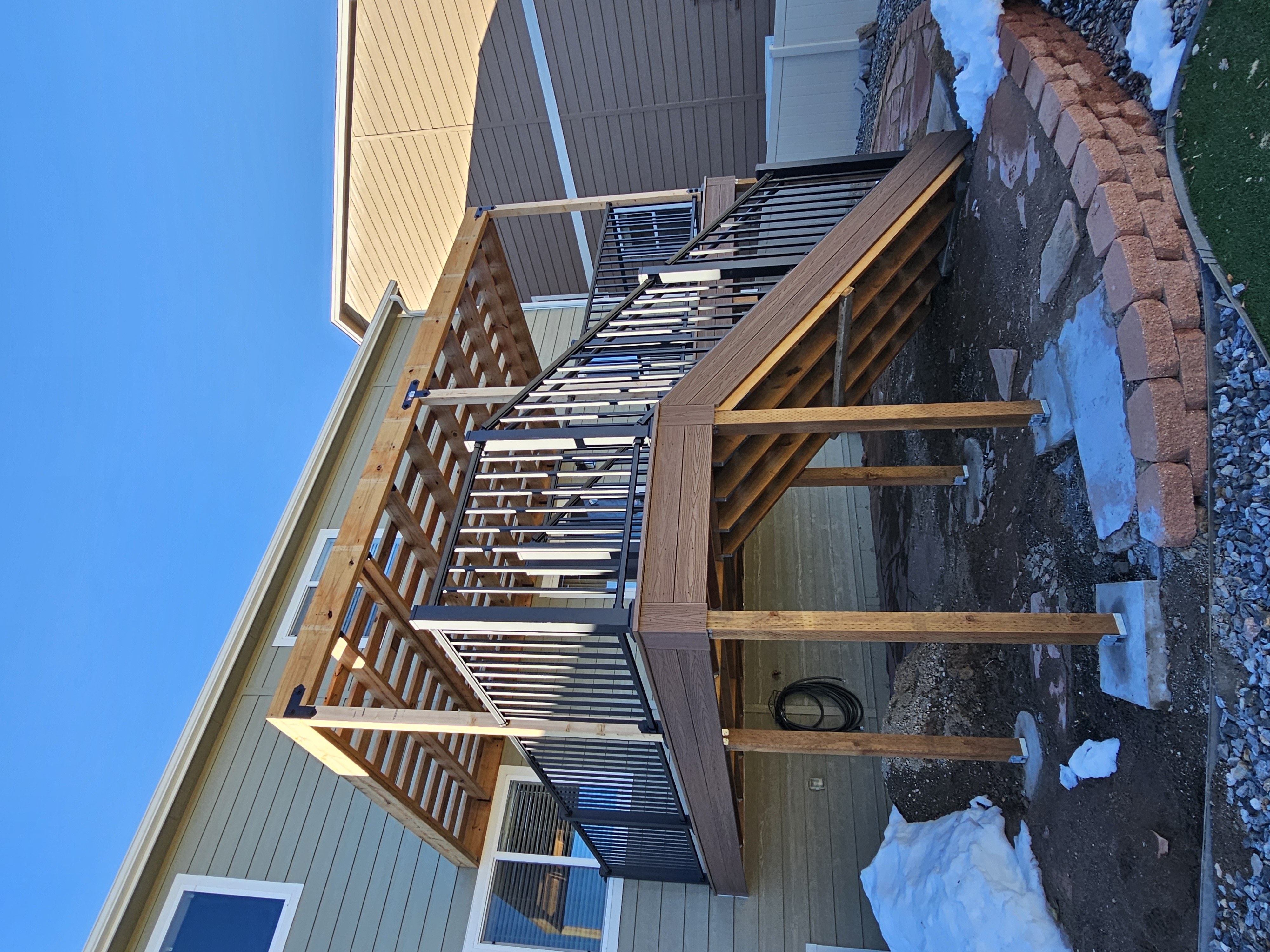 Stained wood deck with post-cap lighting at dusk