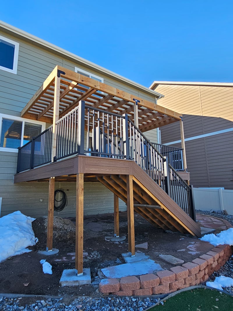 Stained wood deck with post-cap lighting at dusk