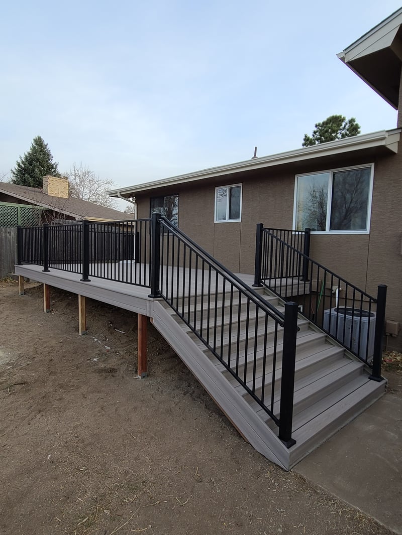 Stained wood deck with post-cap lighting at dusk