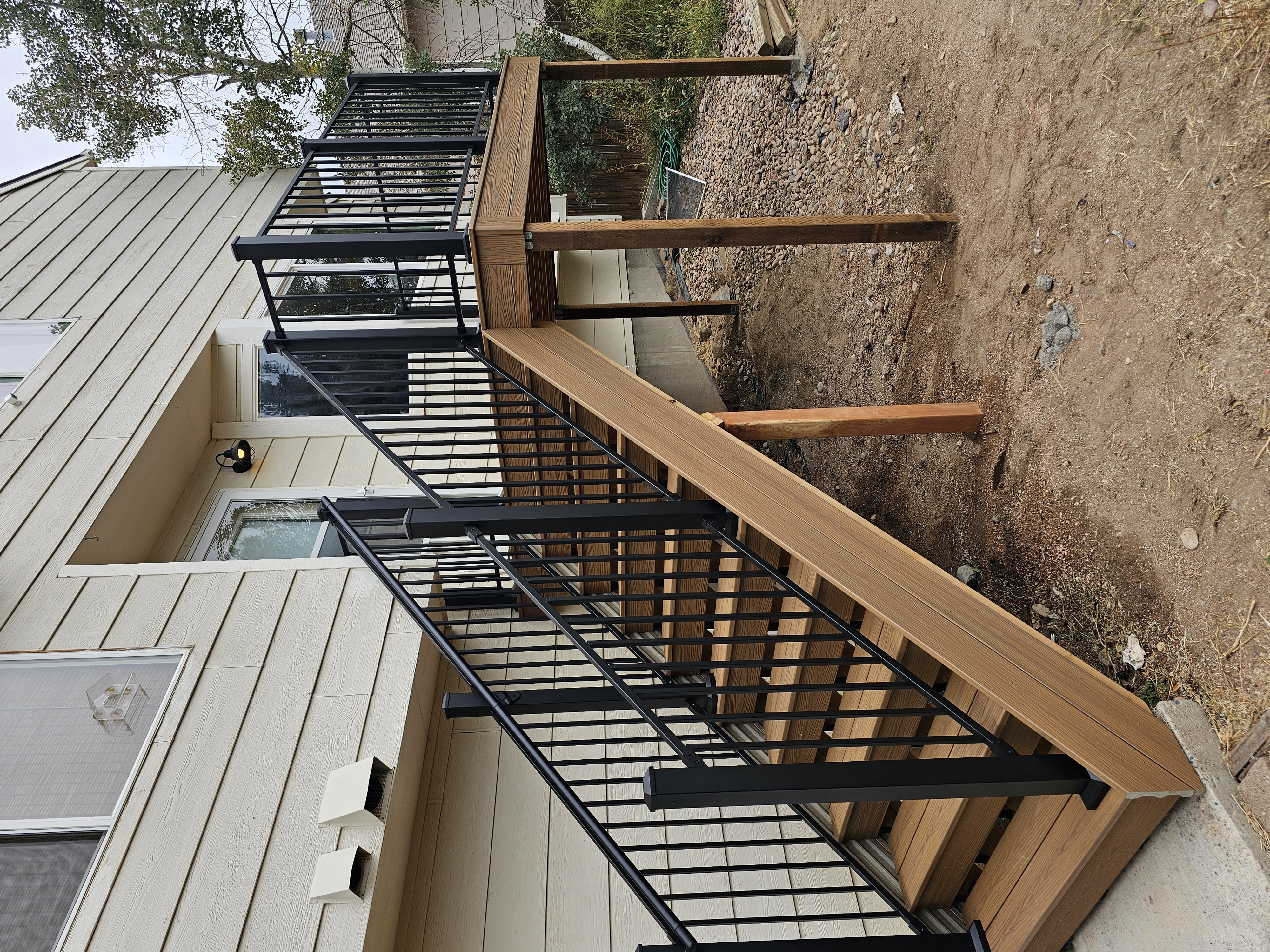 Multi-level custom wood deck with railings in Colorado Springs