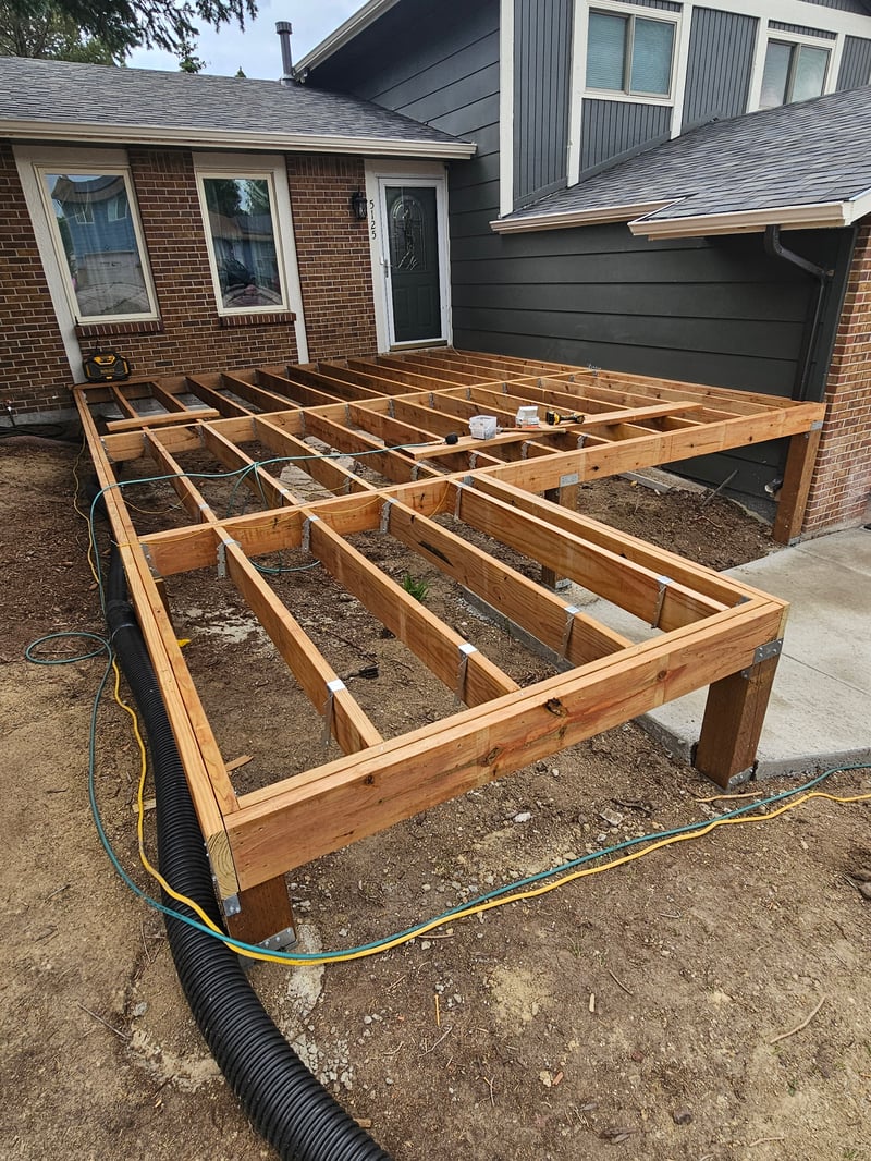 Low-profile ground-level deck with wide plank composite boards