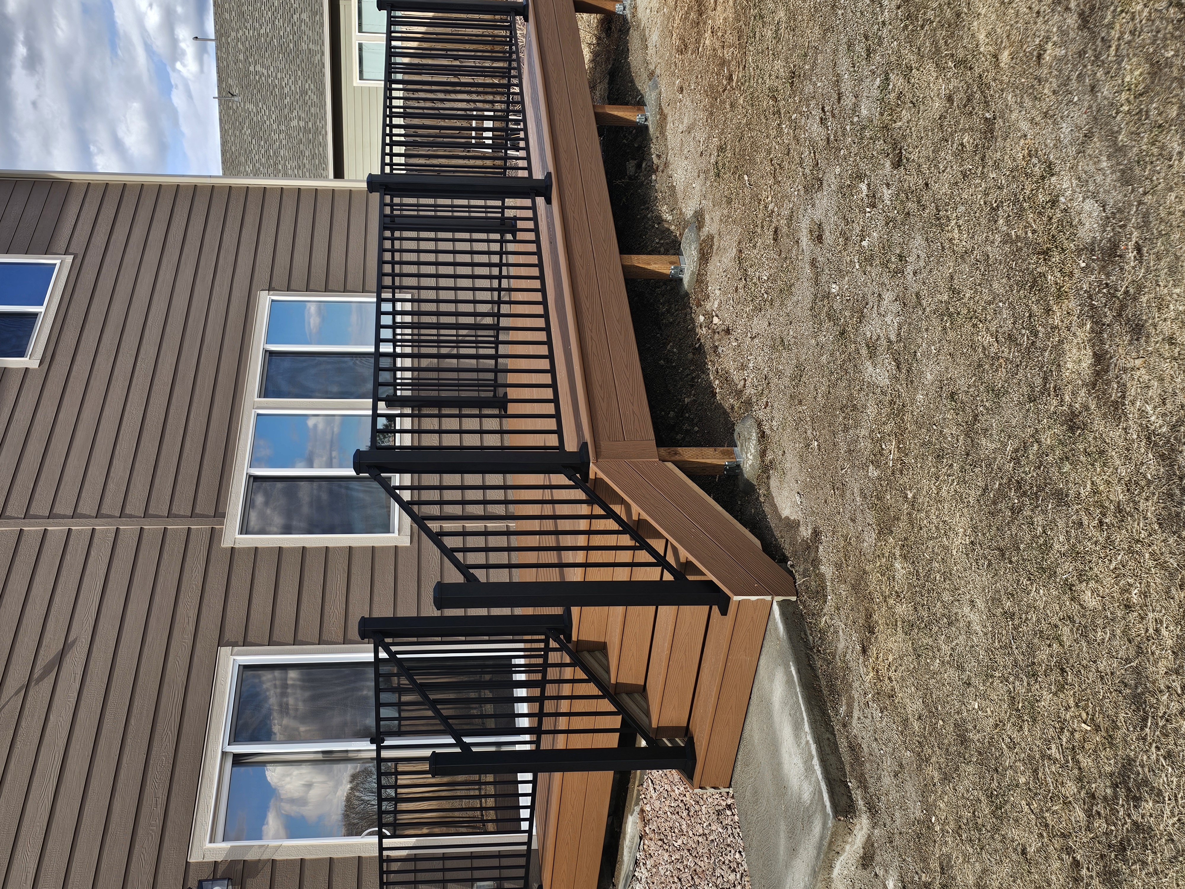 Low-profile ground-level deck with wide plank composite boards