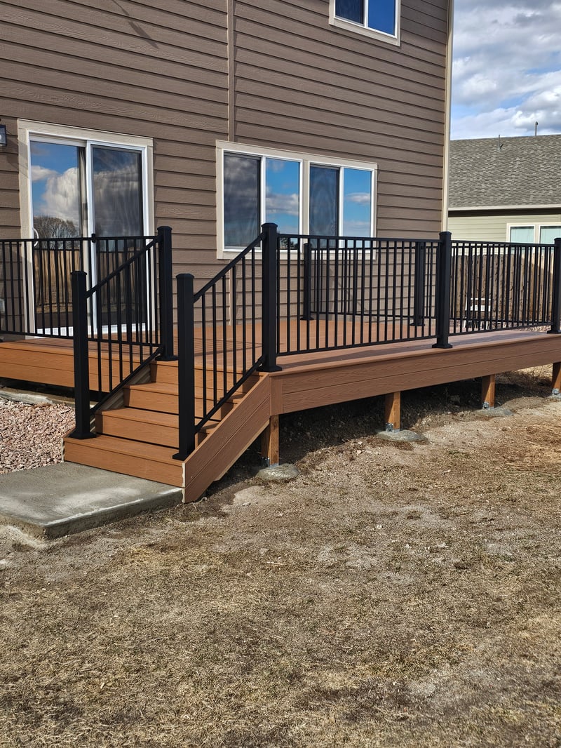 Low-profile ground-level deck with wide plank composite boards