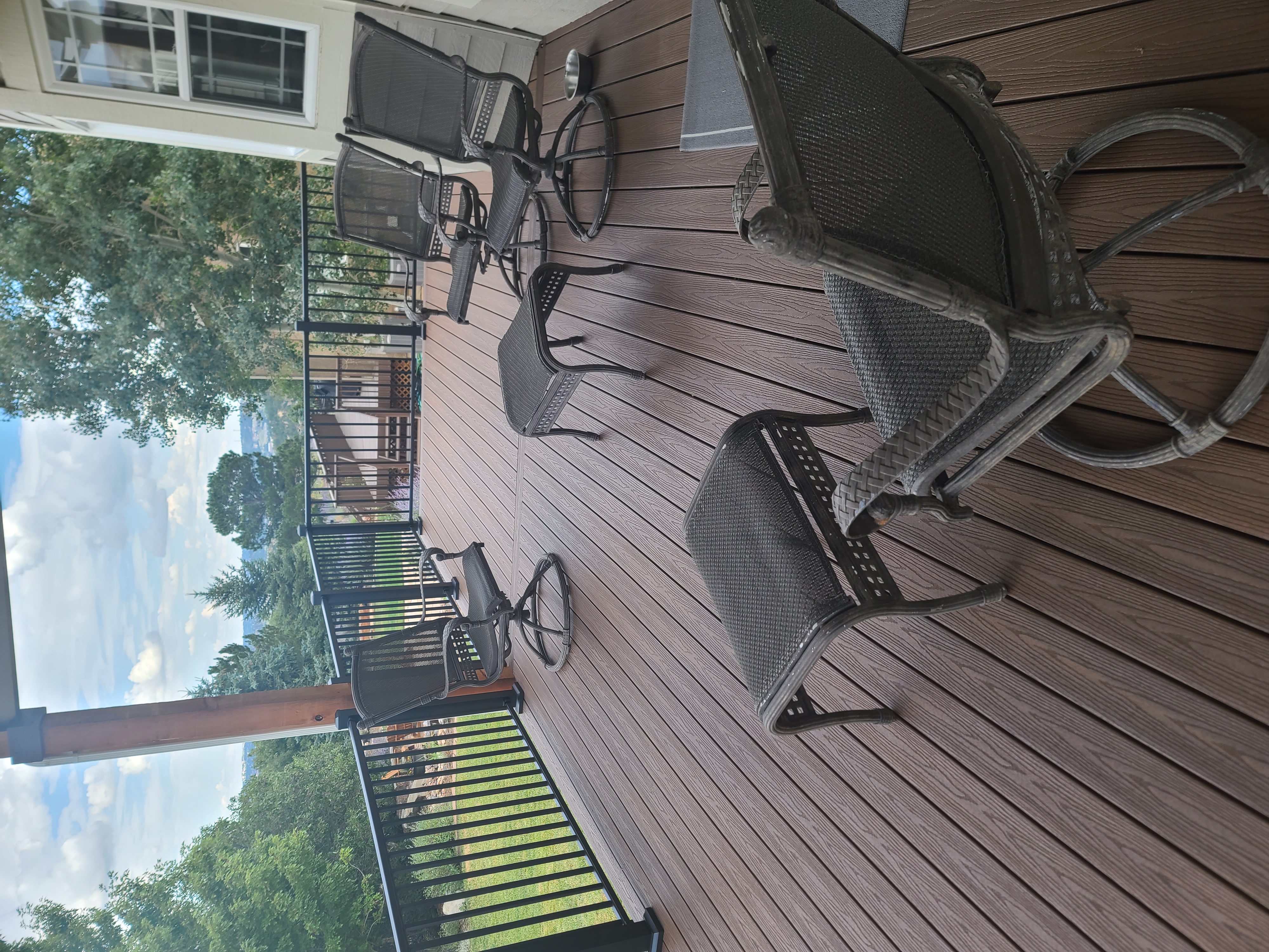 Stained wood deck with post-cap lighting at dusk