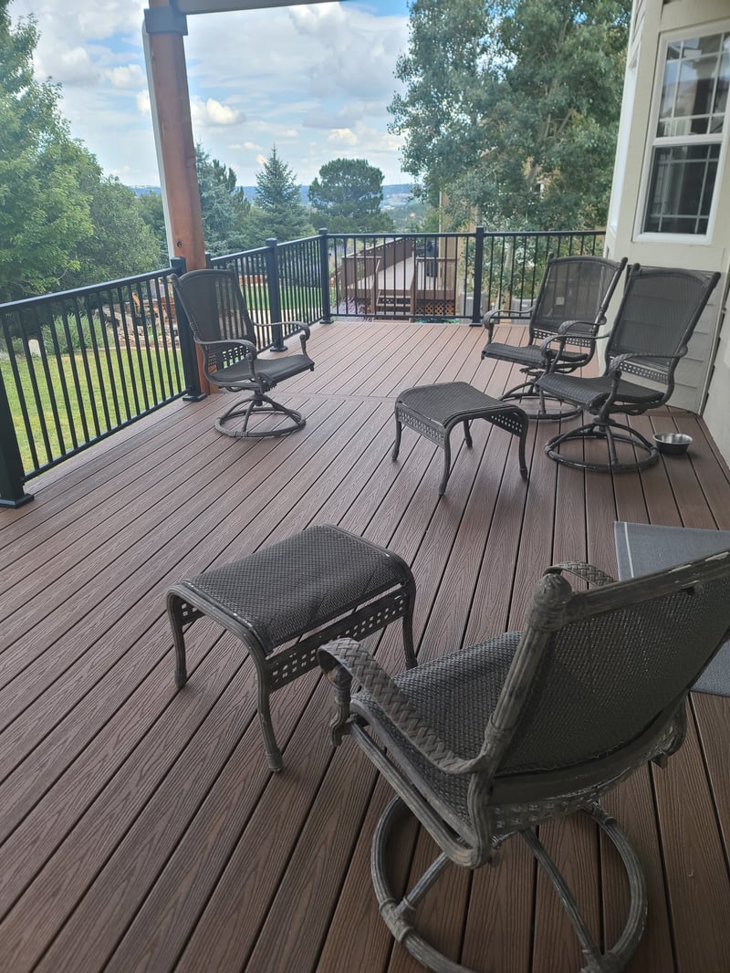 Stained wood deck with post-cap lighting at dusk