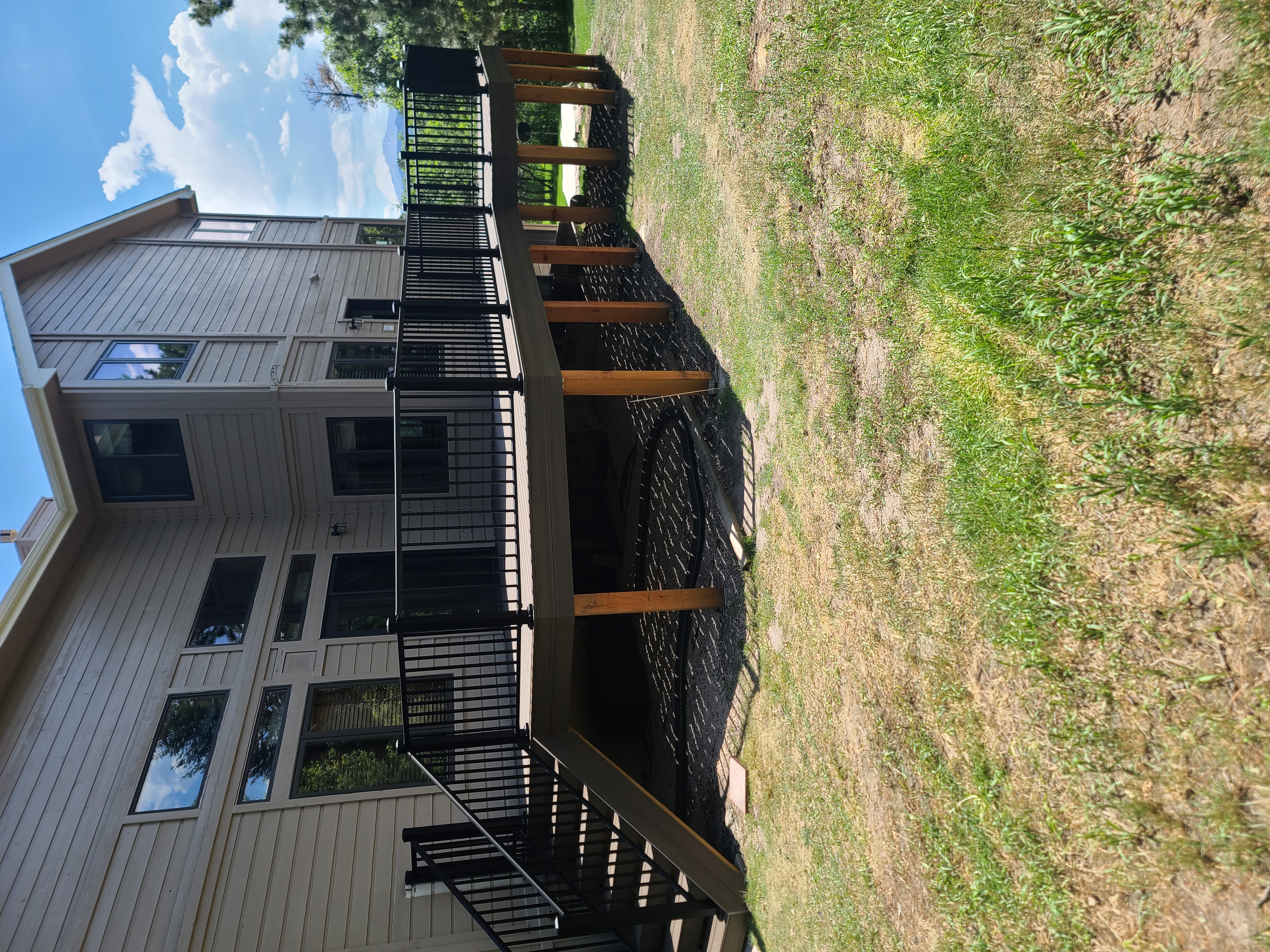 Low-profile ground-level deck with wide plank composite boards