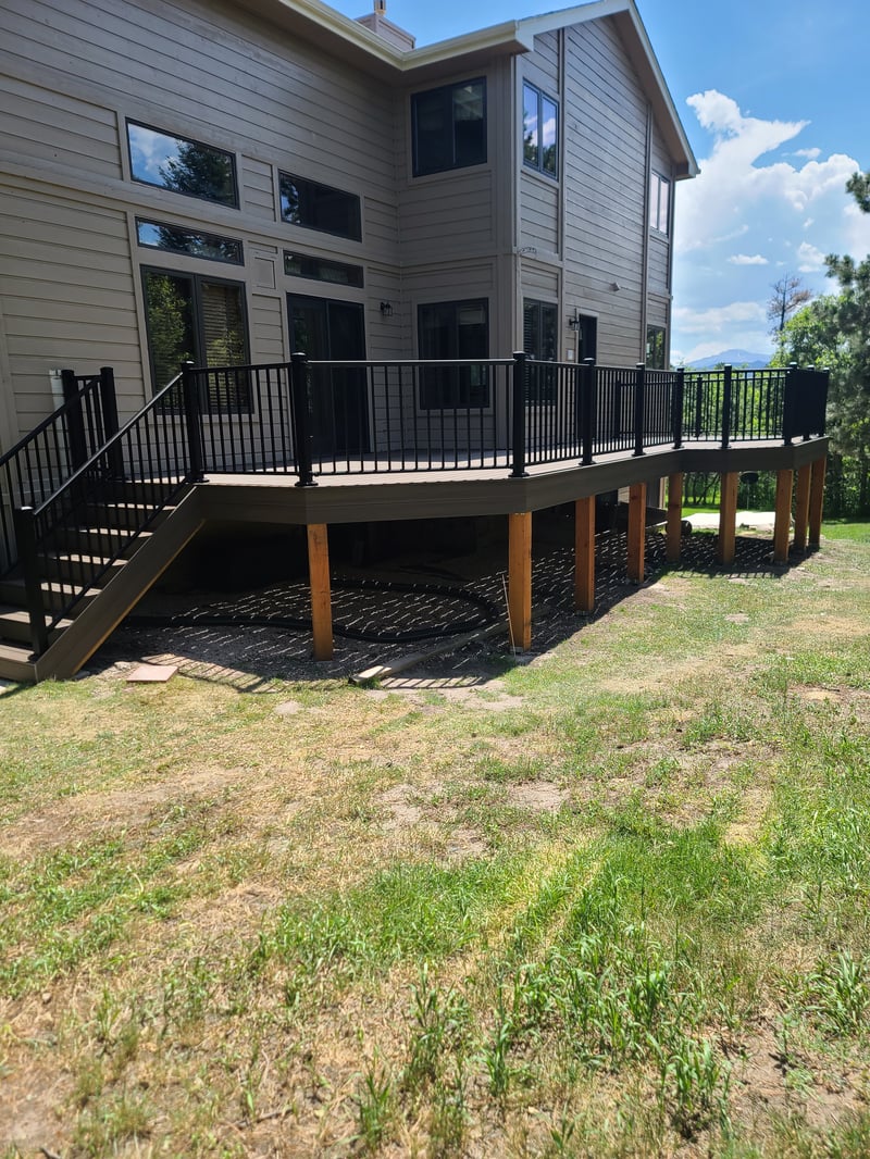 Low-profile ground-level deck with wide plank composite boards