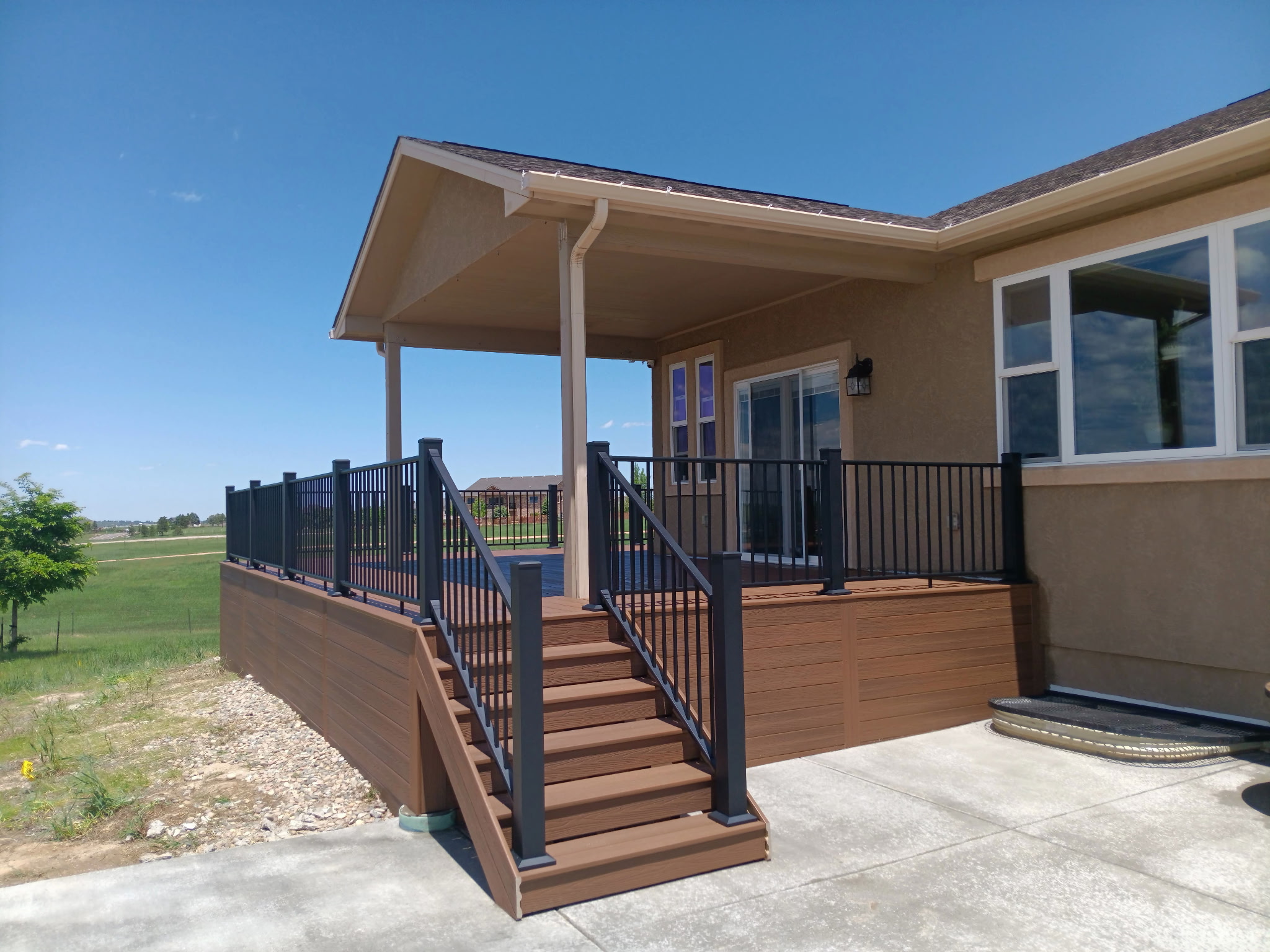Low-profile ground-level deck with wide plank composite boards