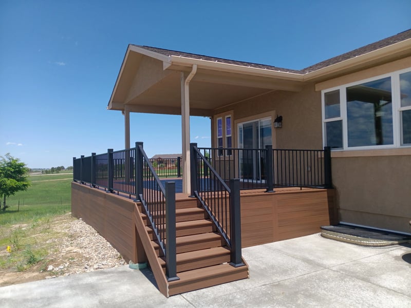 Low-profile ground-level deck with wide plank composite boards