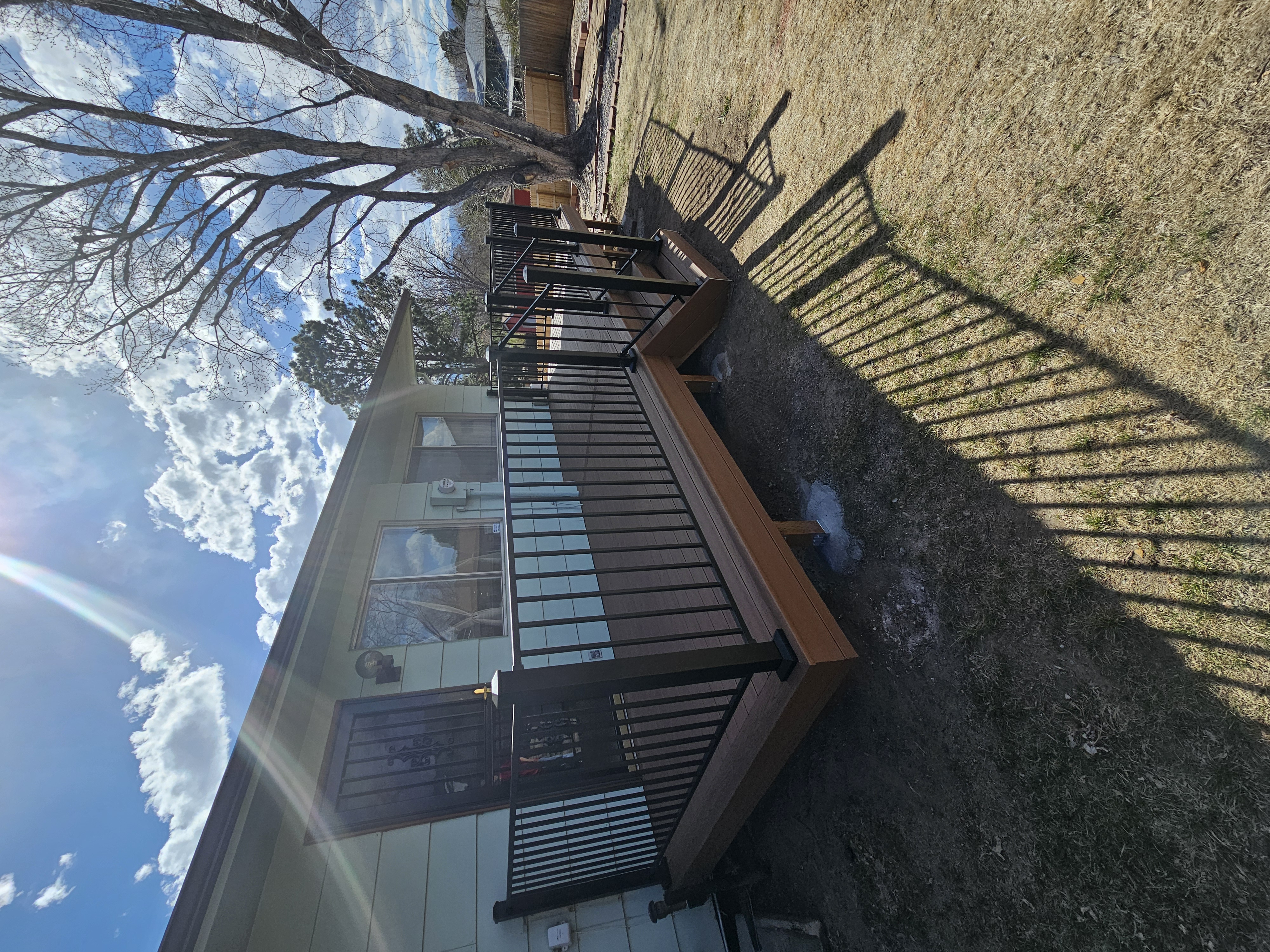 Low-profile ground-level deck with wide plank composite boards