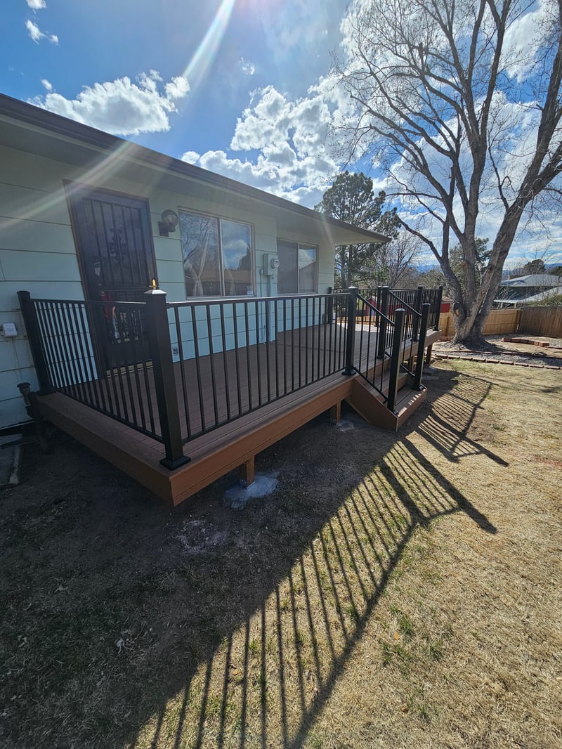 Low-profile ground-level deck with wide plank composite boards