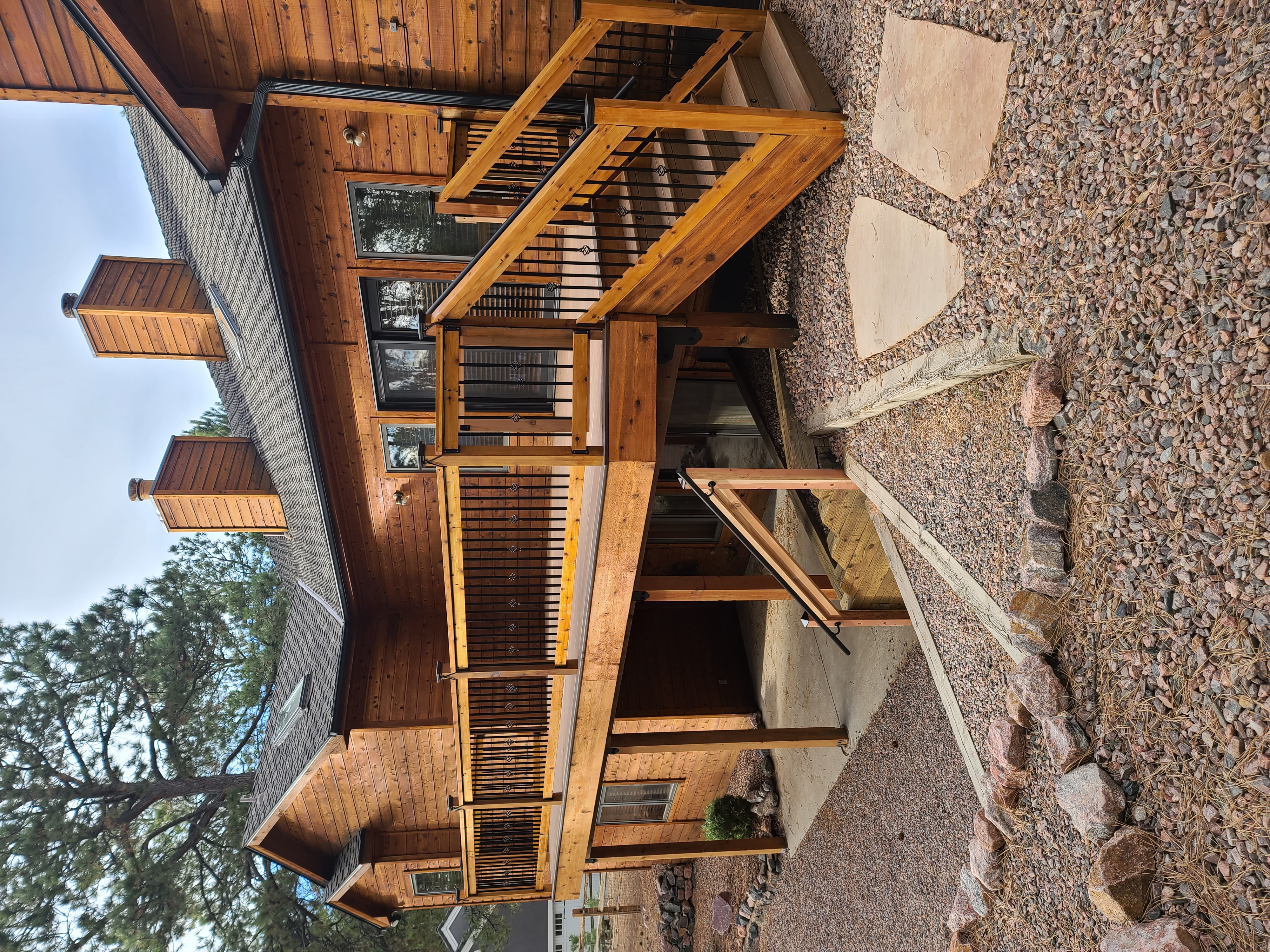 Stained wood deck with post-cap lighting at dusk