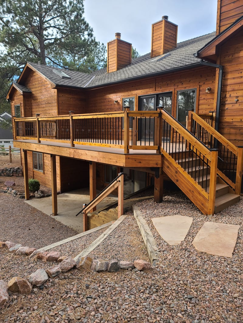 Stained wood deck with post-cap lighting at dusk