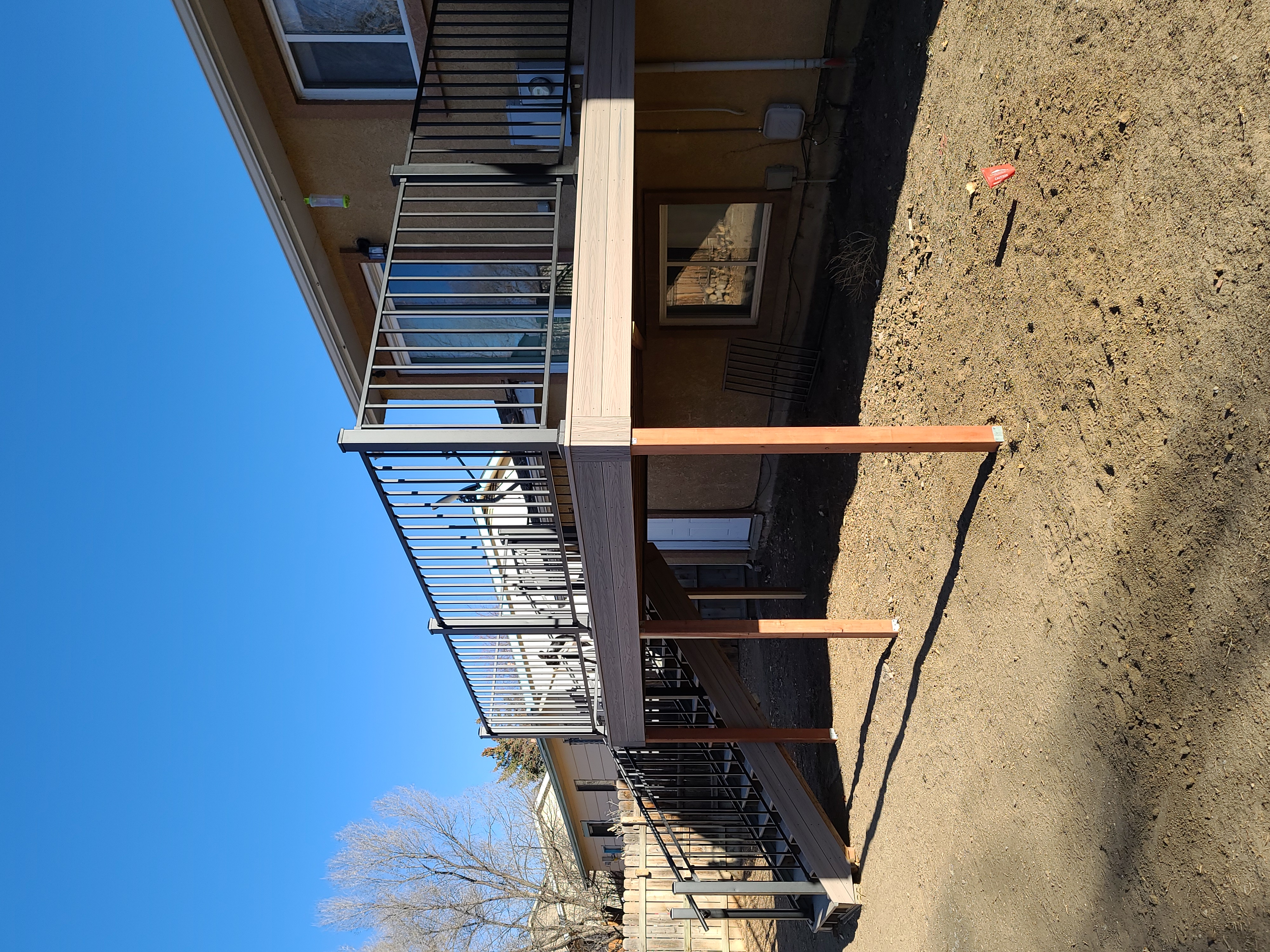 Multi-level custom wood deck with railings in Colorado Springs