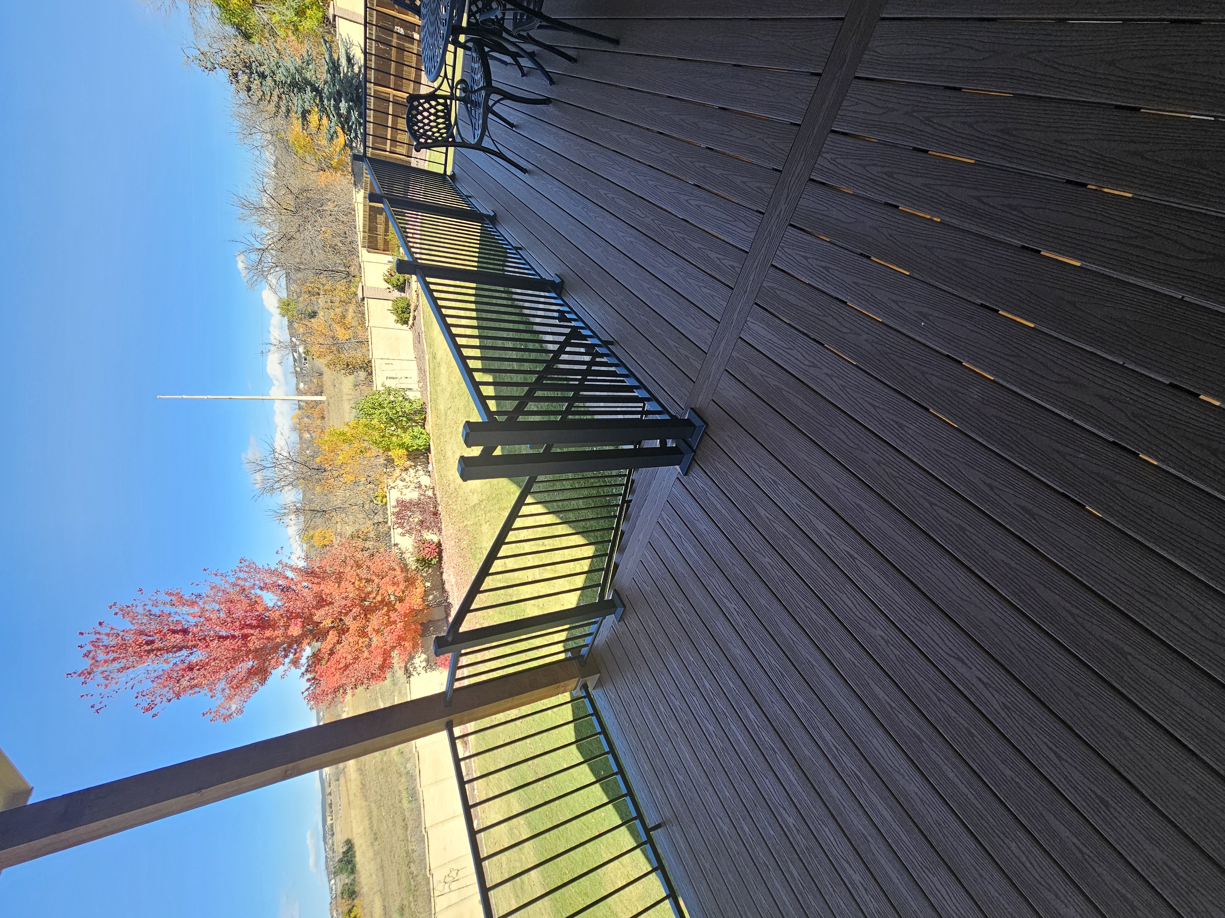 Low-profile ground-level deck with wide plank composite boards