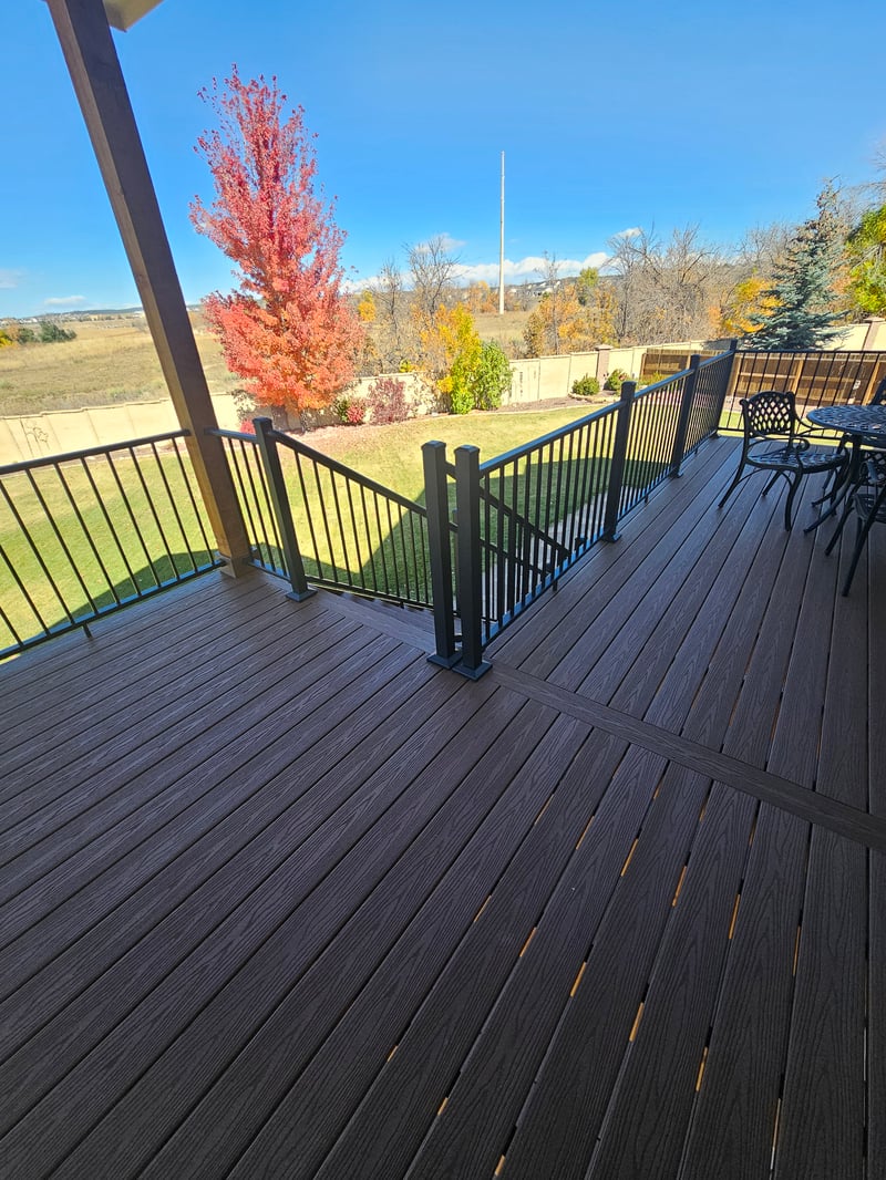 Low-profile ground-level deck with wide plank composite boards