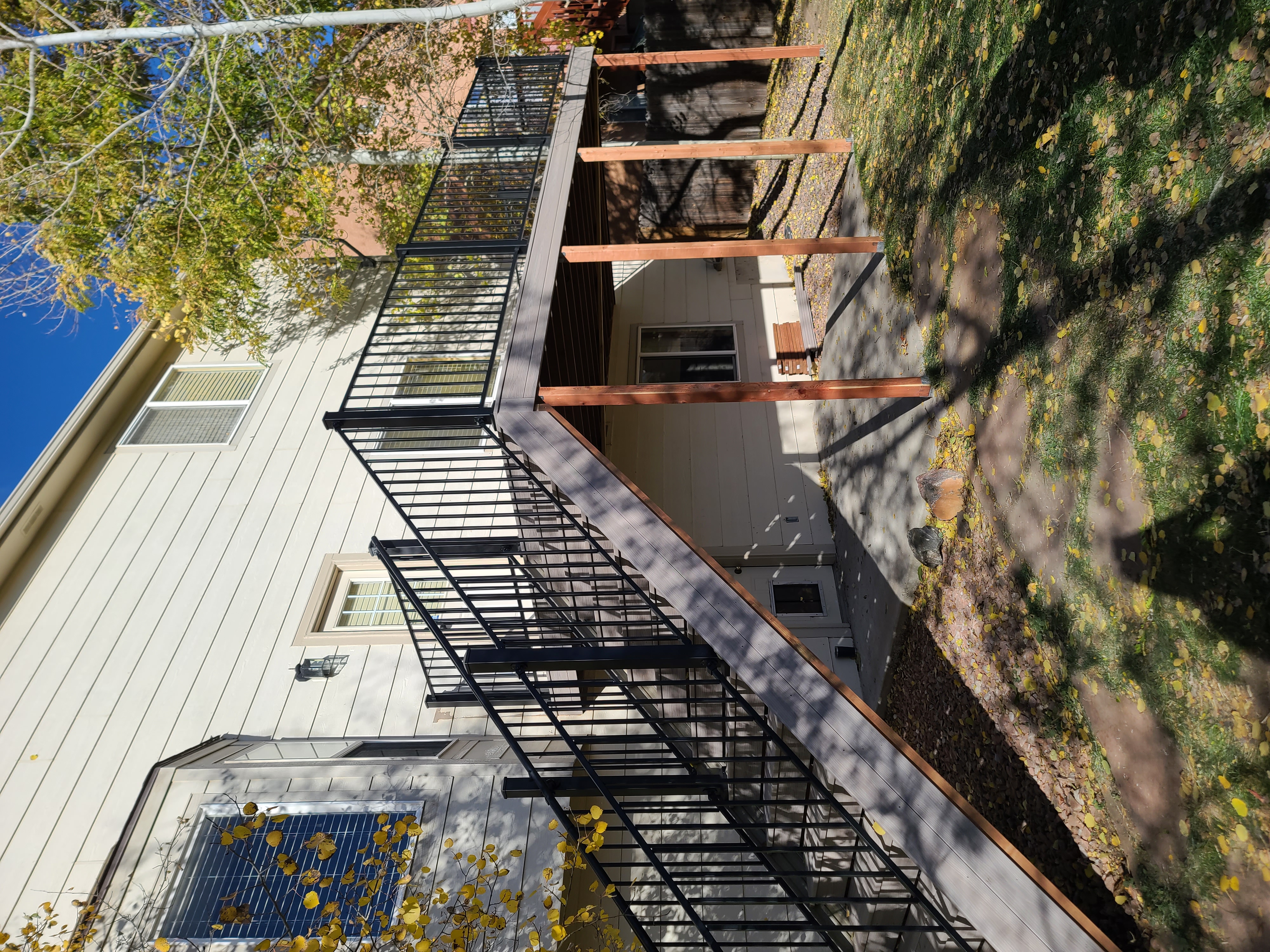 Walk-out deck with stairs to a landscaped yard