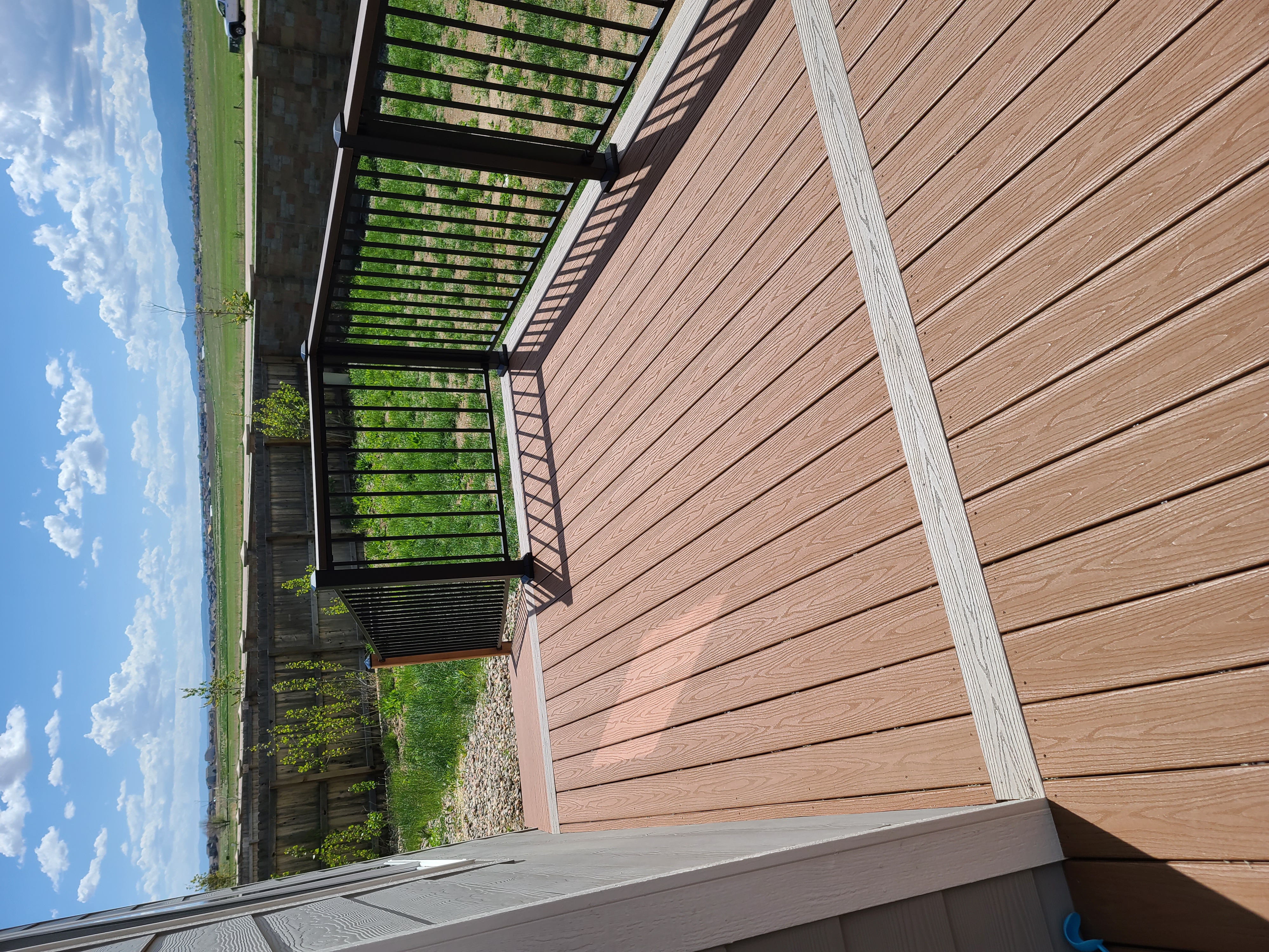 Low-profile ground-level deck with wide plank composite boards