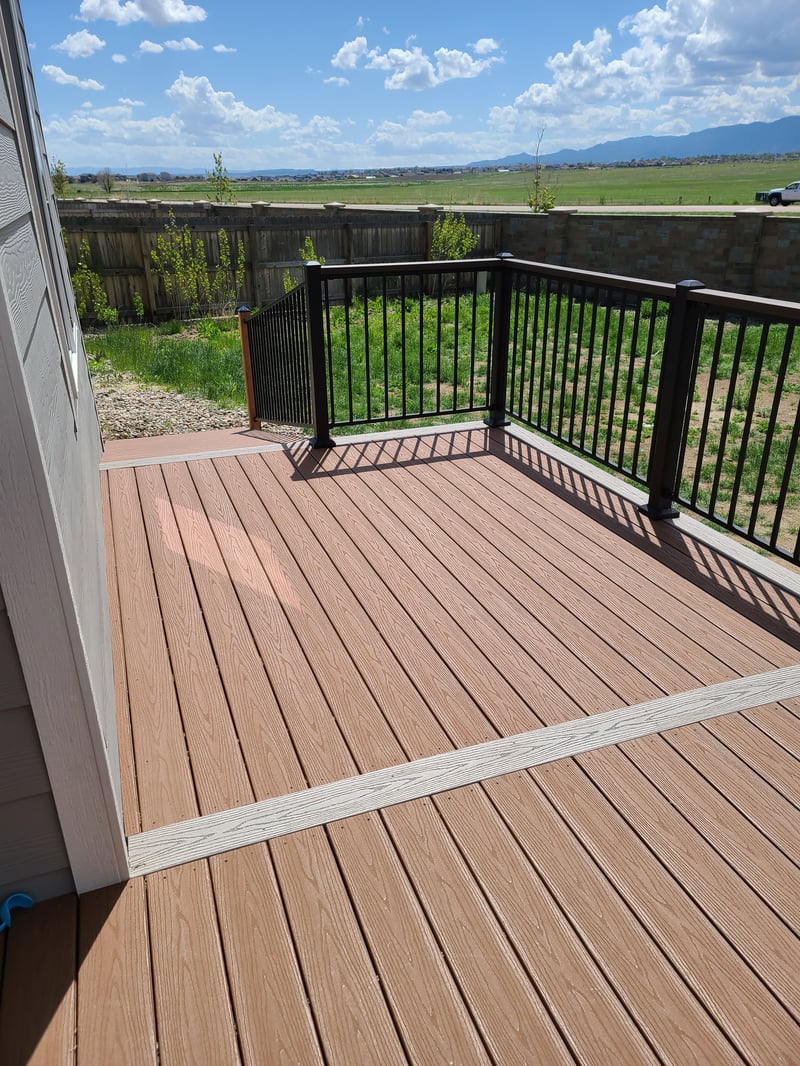Low-profile ground-level deck with wide plank composite boards