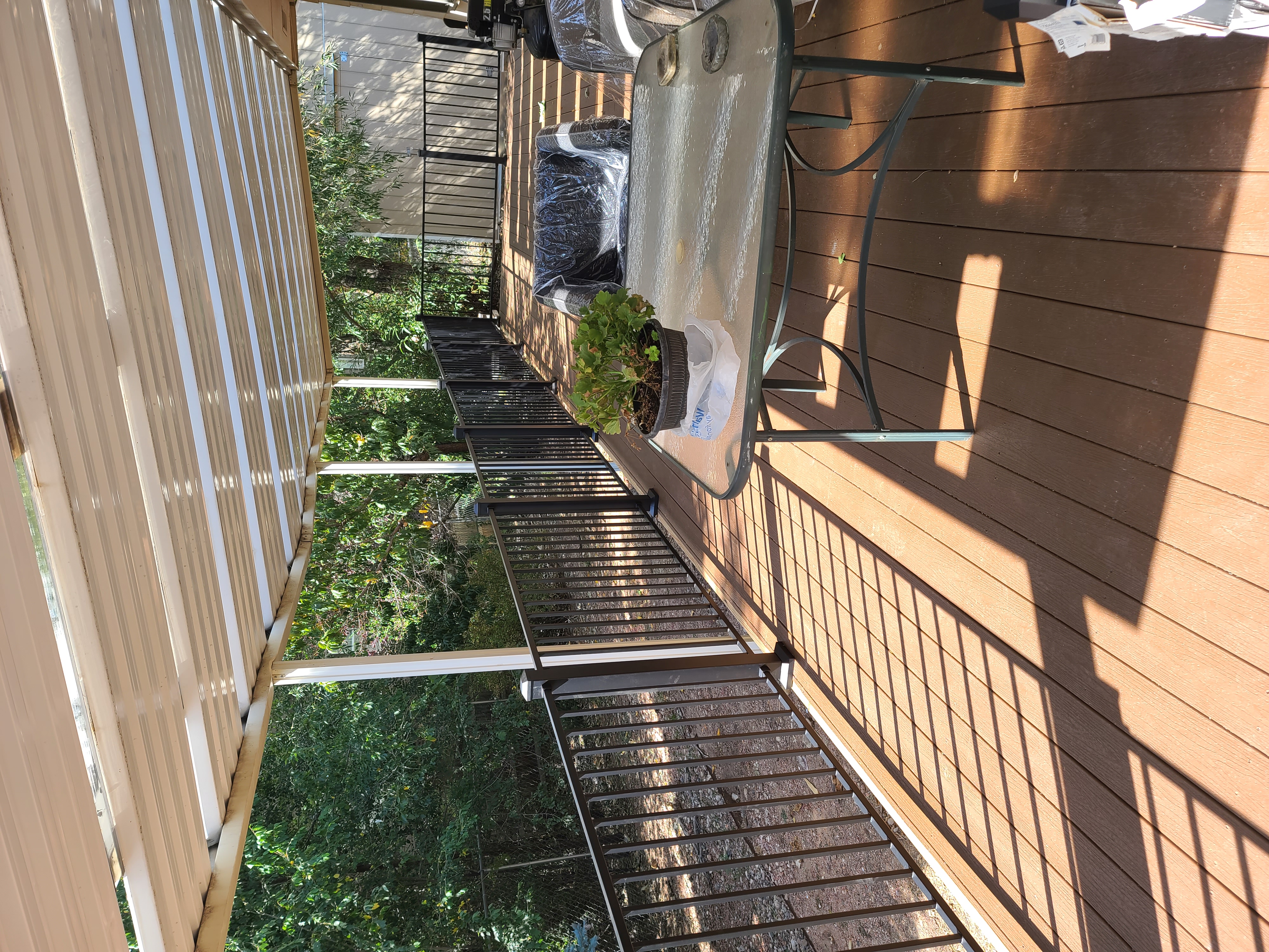 Walk-out deck with stairs to a landscaped yard