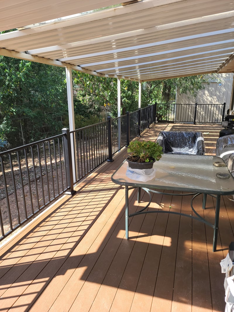 Walk-out deck with stairs to a landscaped yard