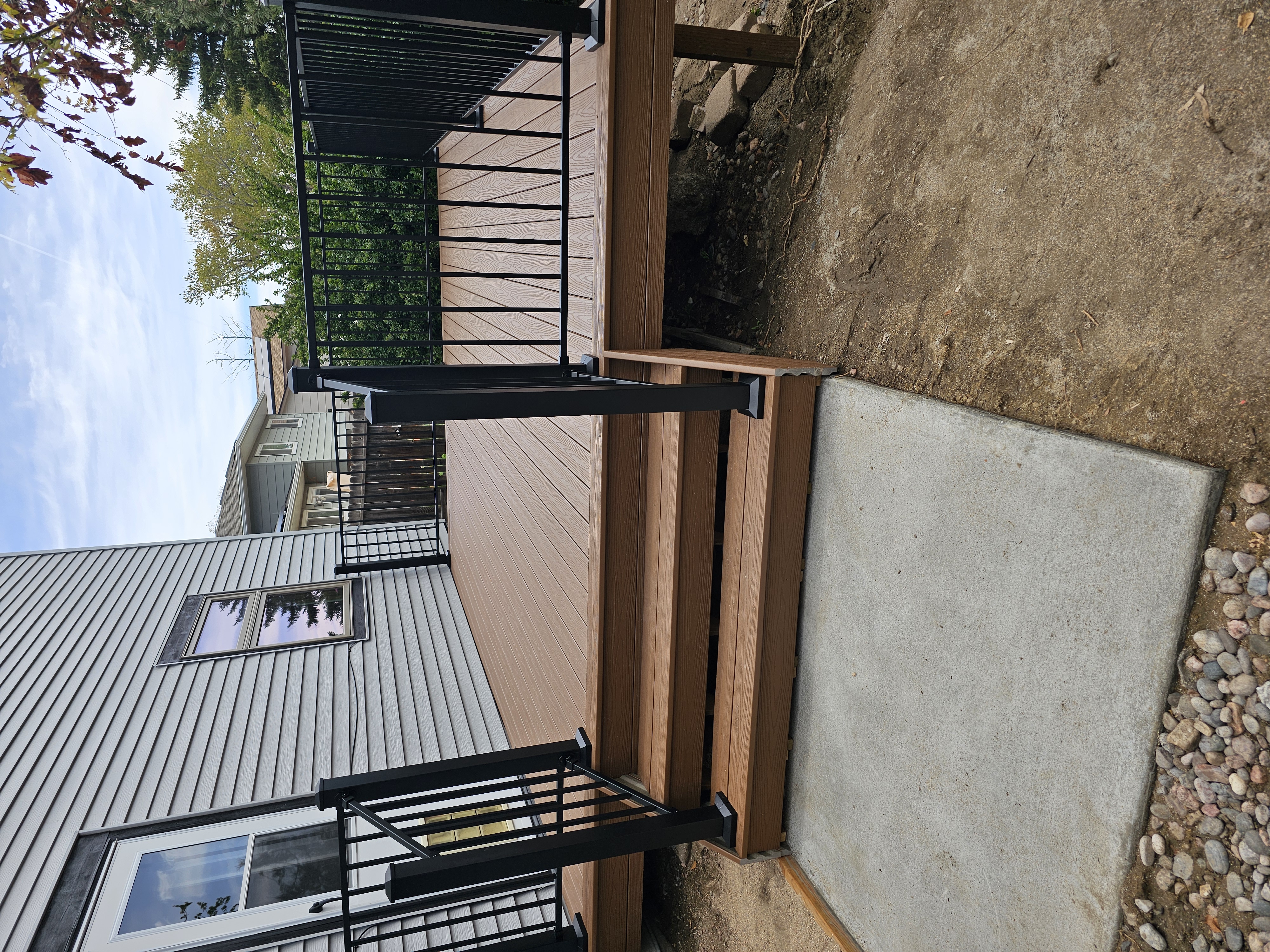 Stained wood deck with post-cap lighting at dusk