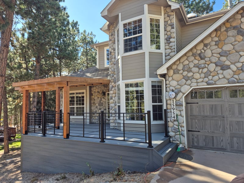 Walk-out deck with stairs to a landscaped yard