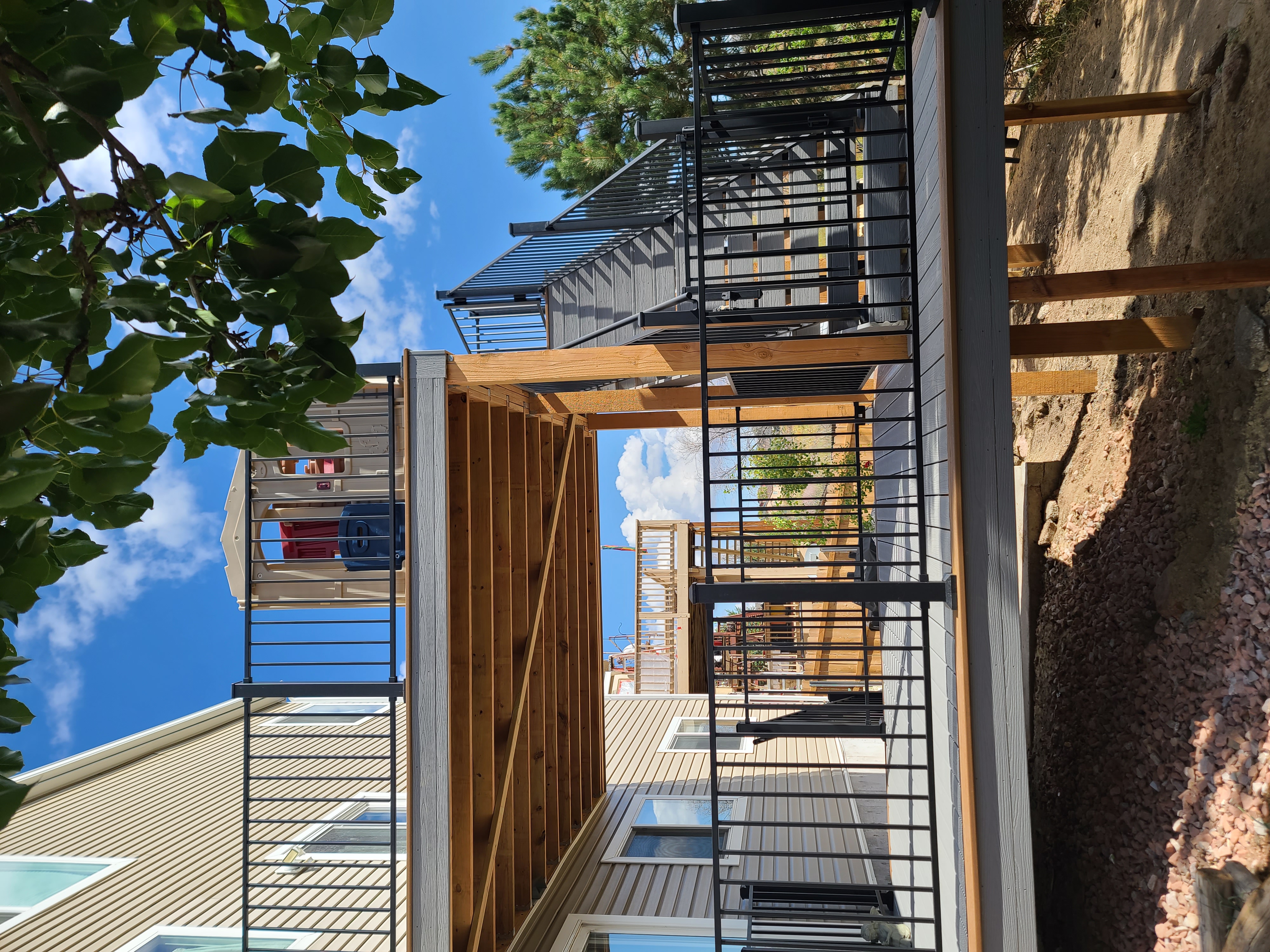 Custom cedar pergola over a backyard deck in the Pikes Peak region