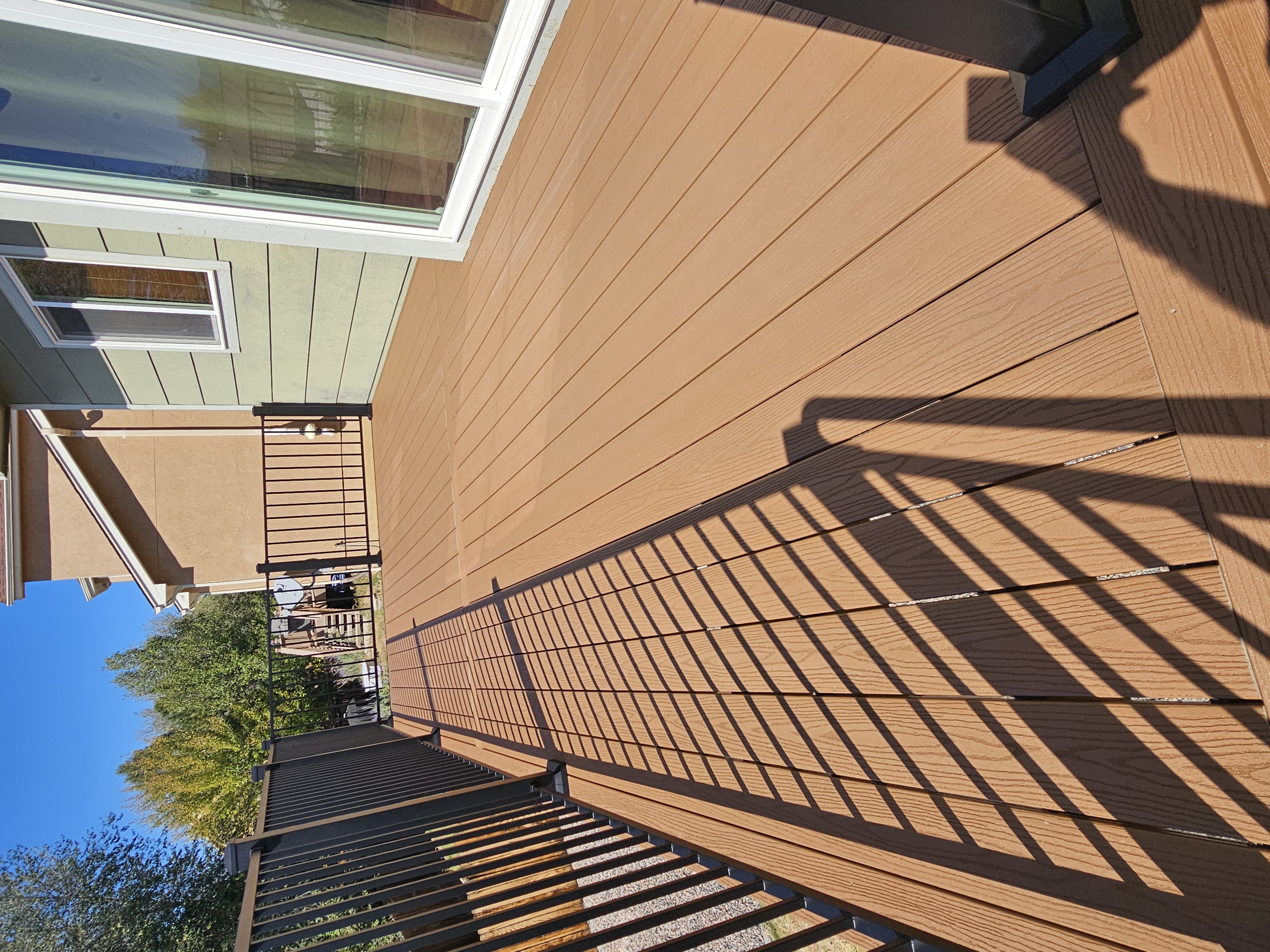 Stained wood deck with post-cap lighting at dusk
