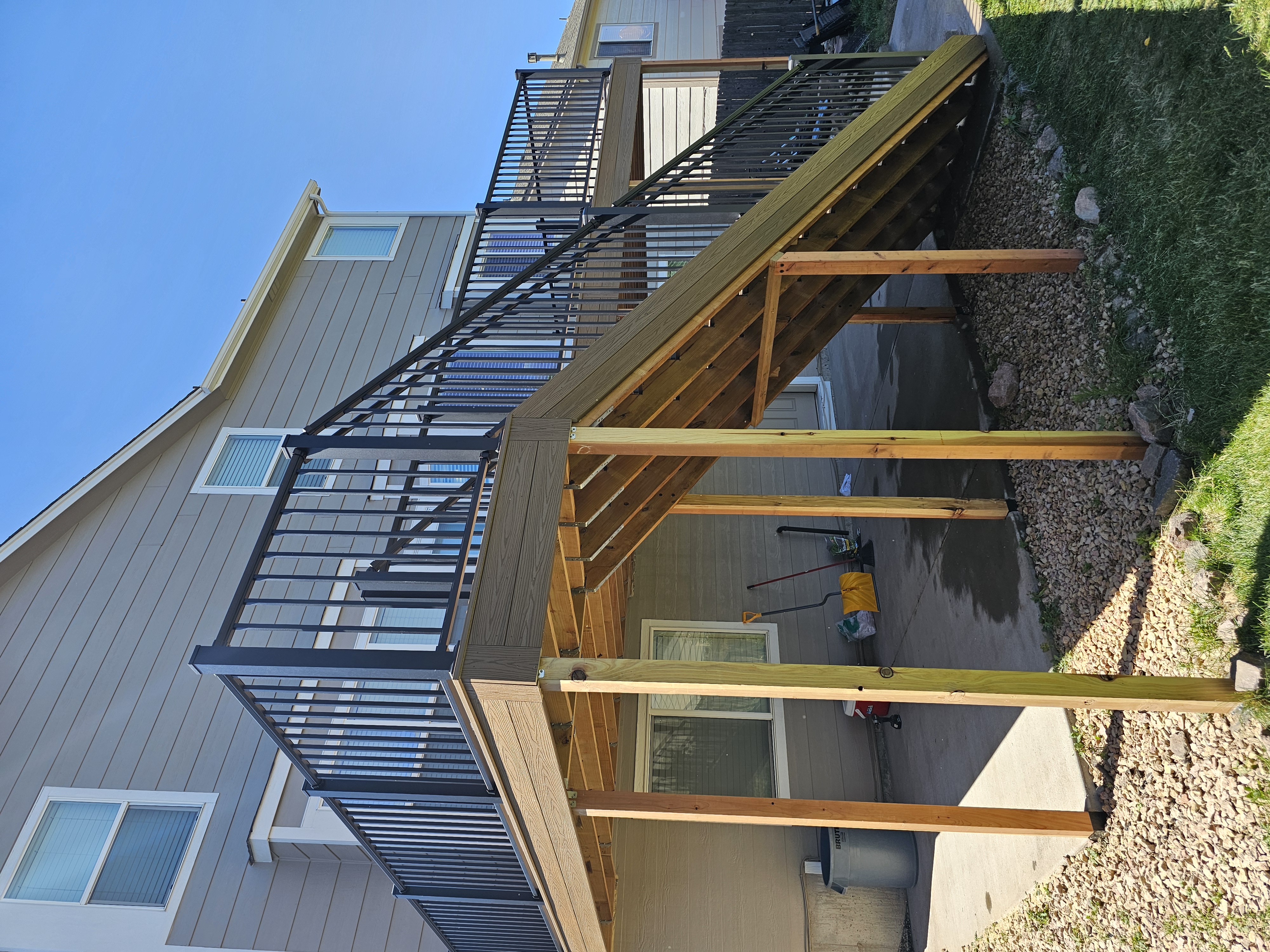 Stained wood deck with post-cap lighting at dusk