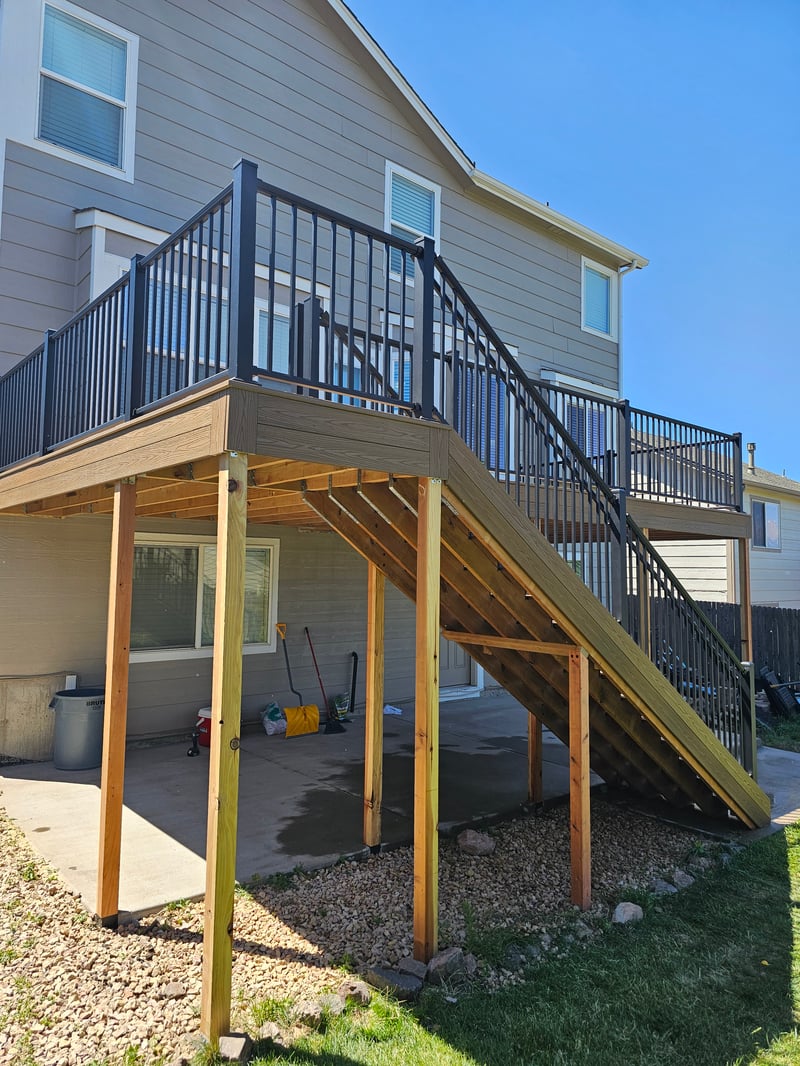 Stained wood deck with post-cap lighting at dusk