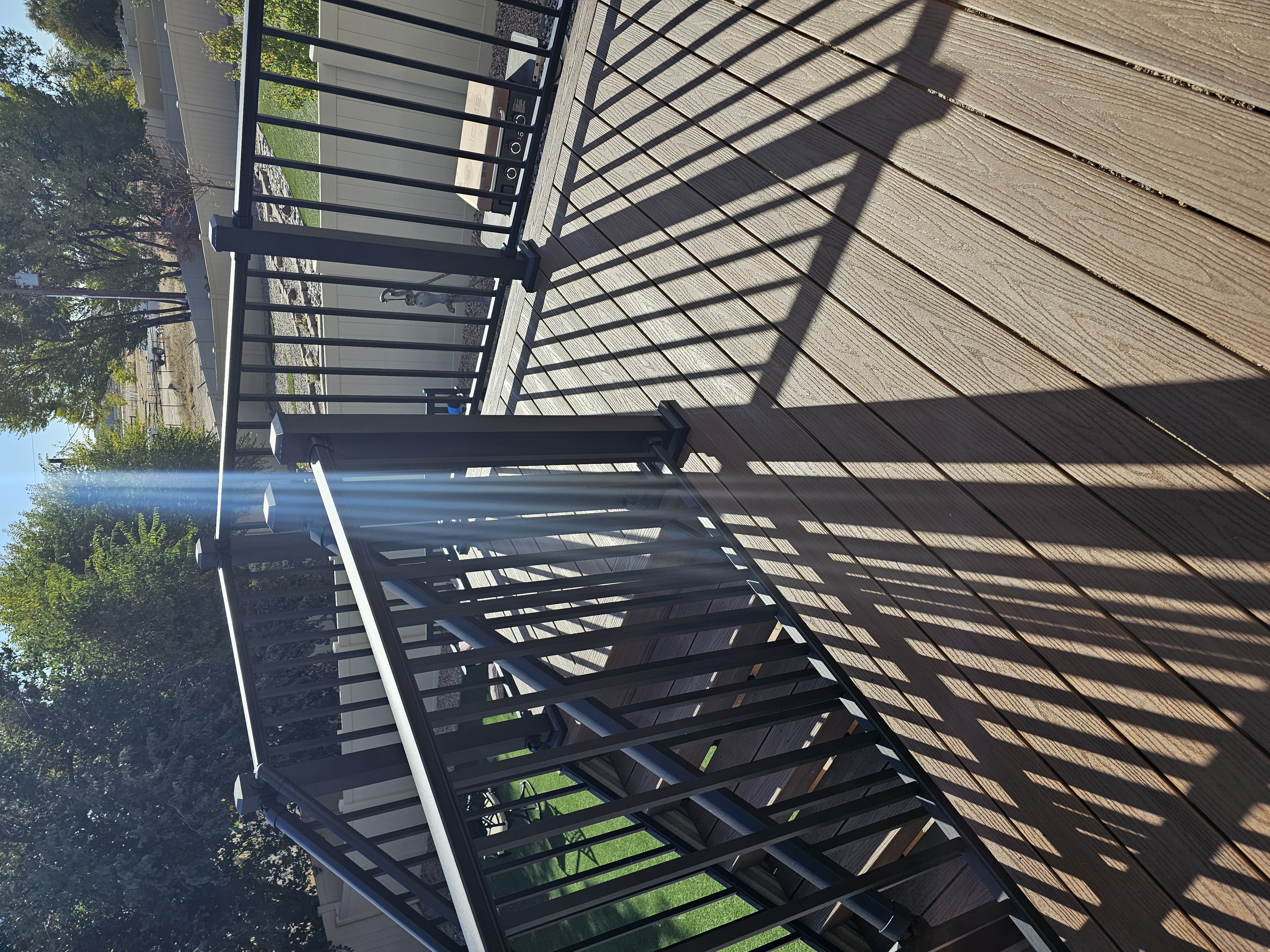 Low-profile ground-level deck with wide plank composite boards