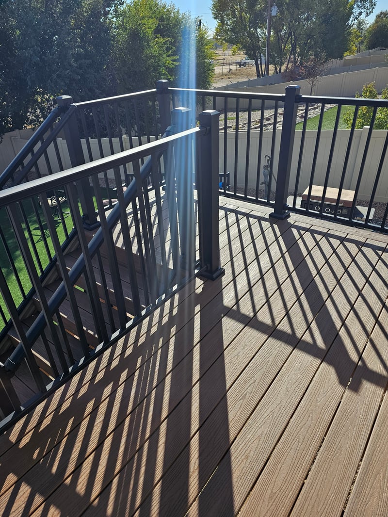 Low-profile ground-level deck with wide plank composite boards