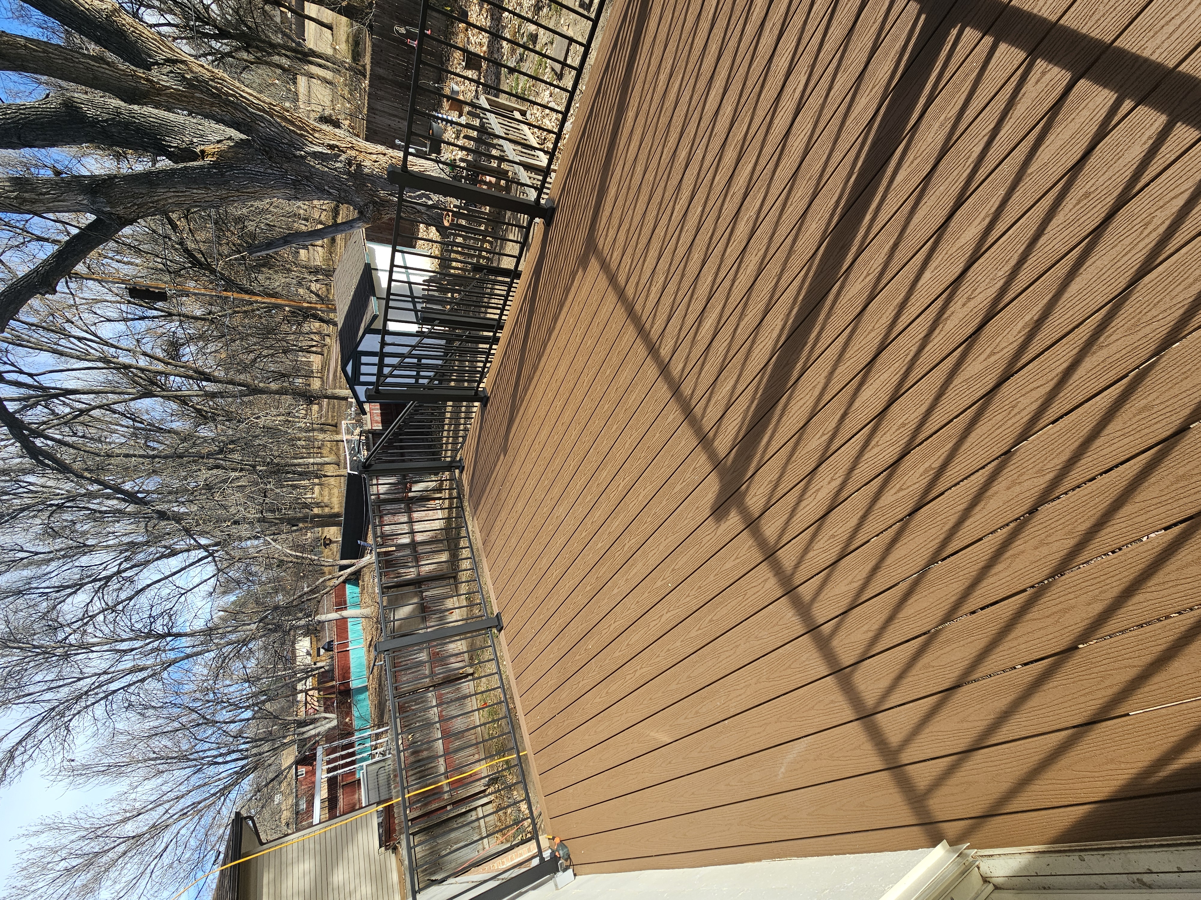 Walk-out deck with stairs to a landscaped yard