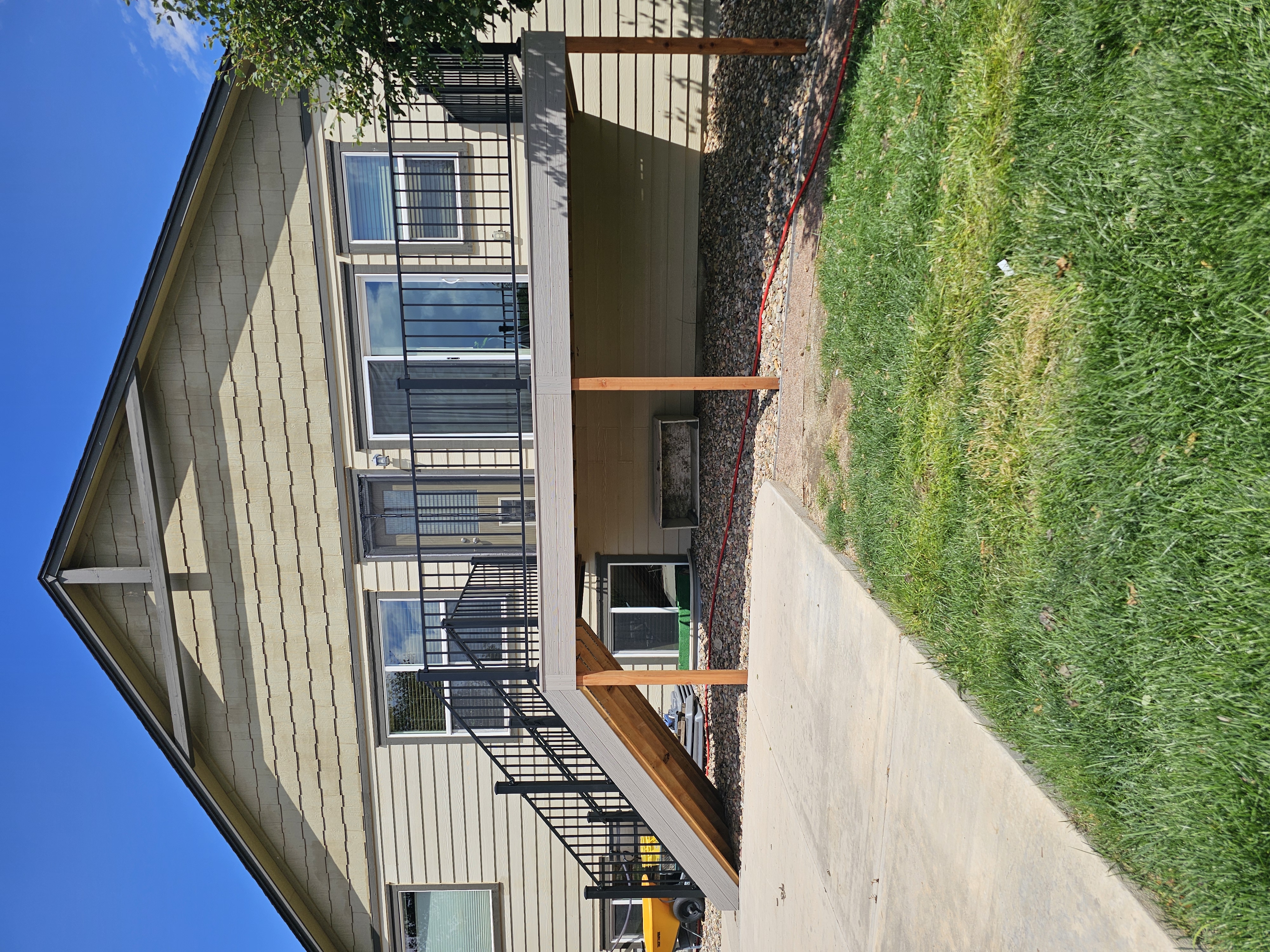 Low-profile ground-level deck with wide plank composite boards
