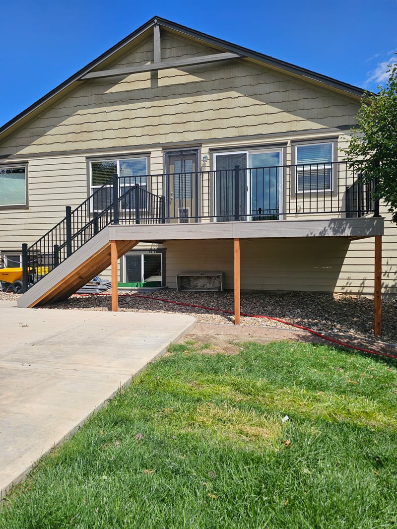 Low-profile ground-level deck with wide plank composite boards
