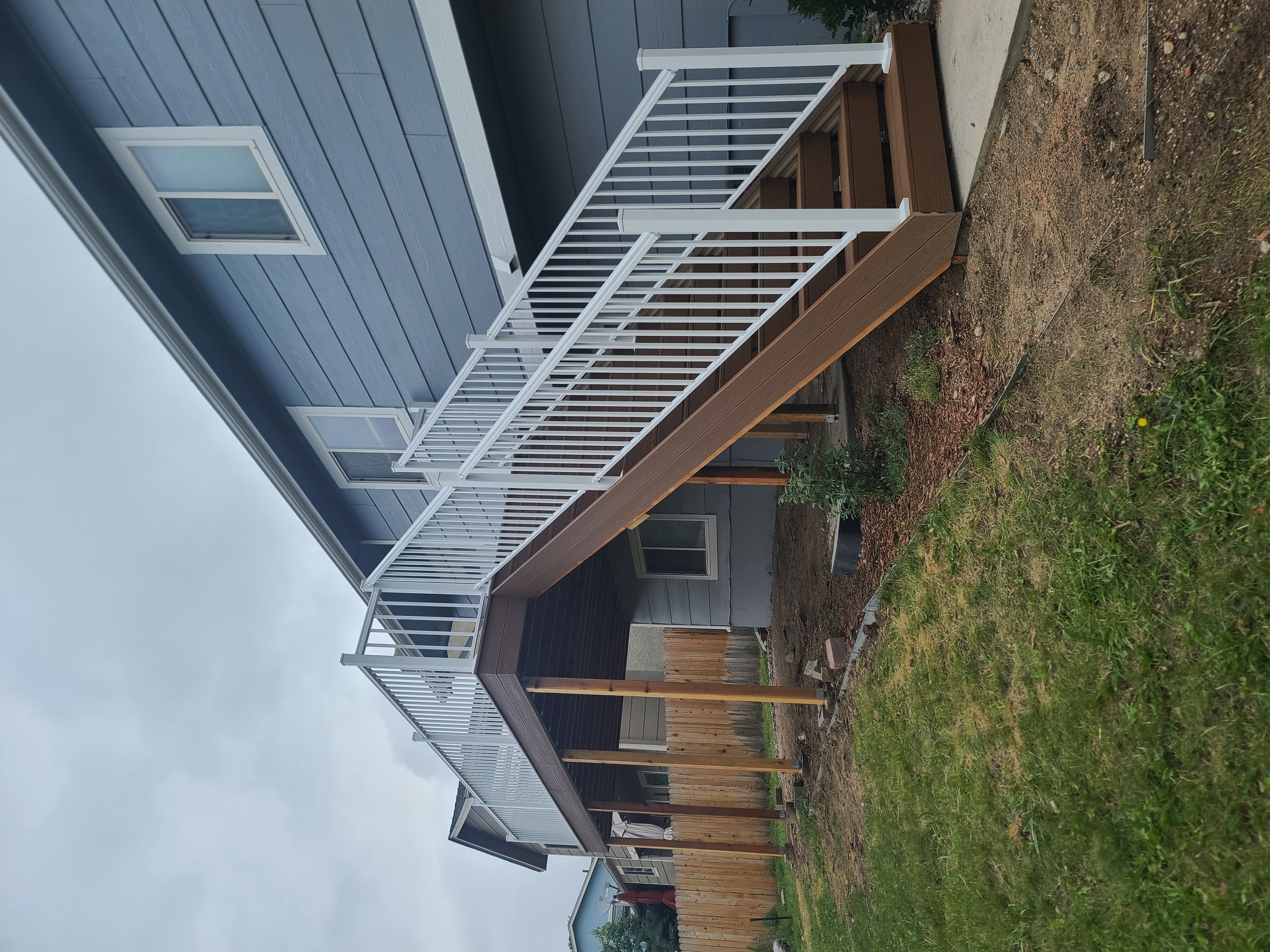 Backyard deck with pergola and outdoor dining area