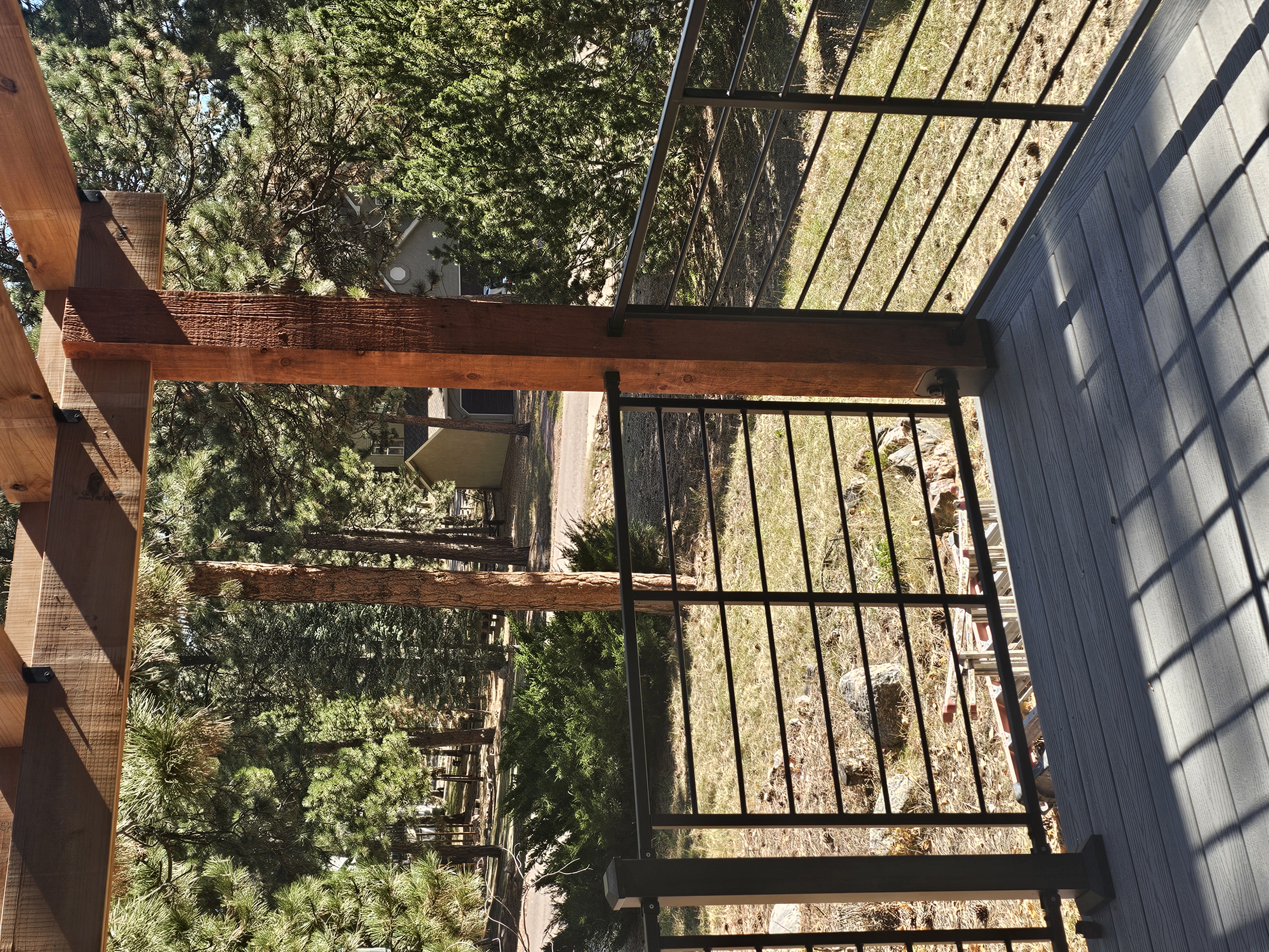Custom cedar pergola over a backyard deck in the Pikes Peak region