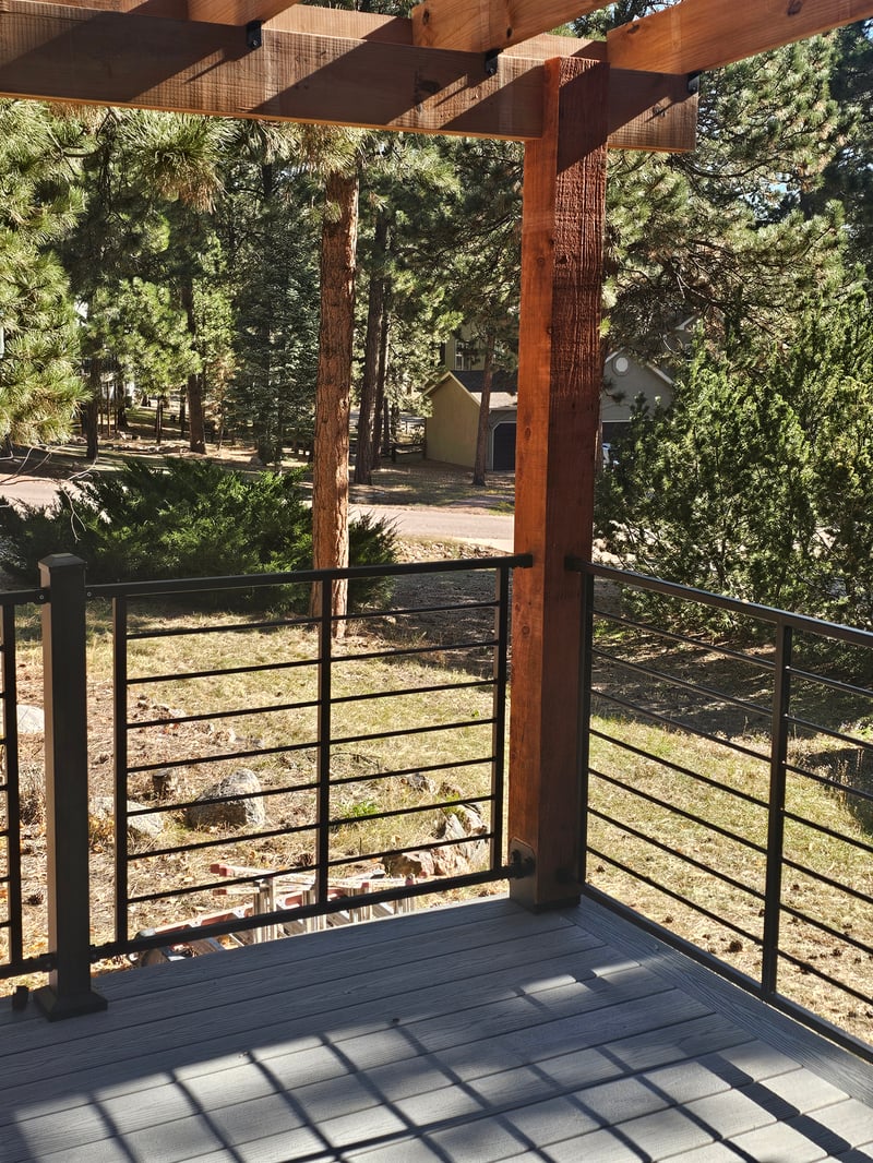Custom cedar pergola over a backyard deck in the Pikes Peak region