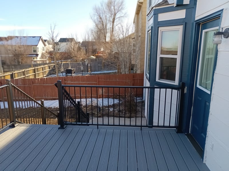 Stained wood deck with post-cap lighting at dusk