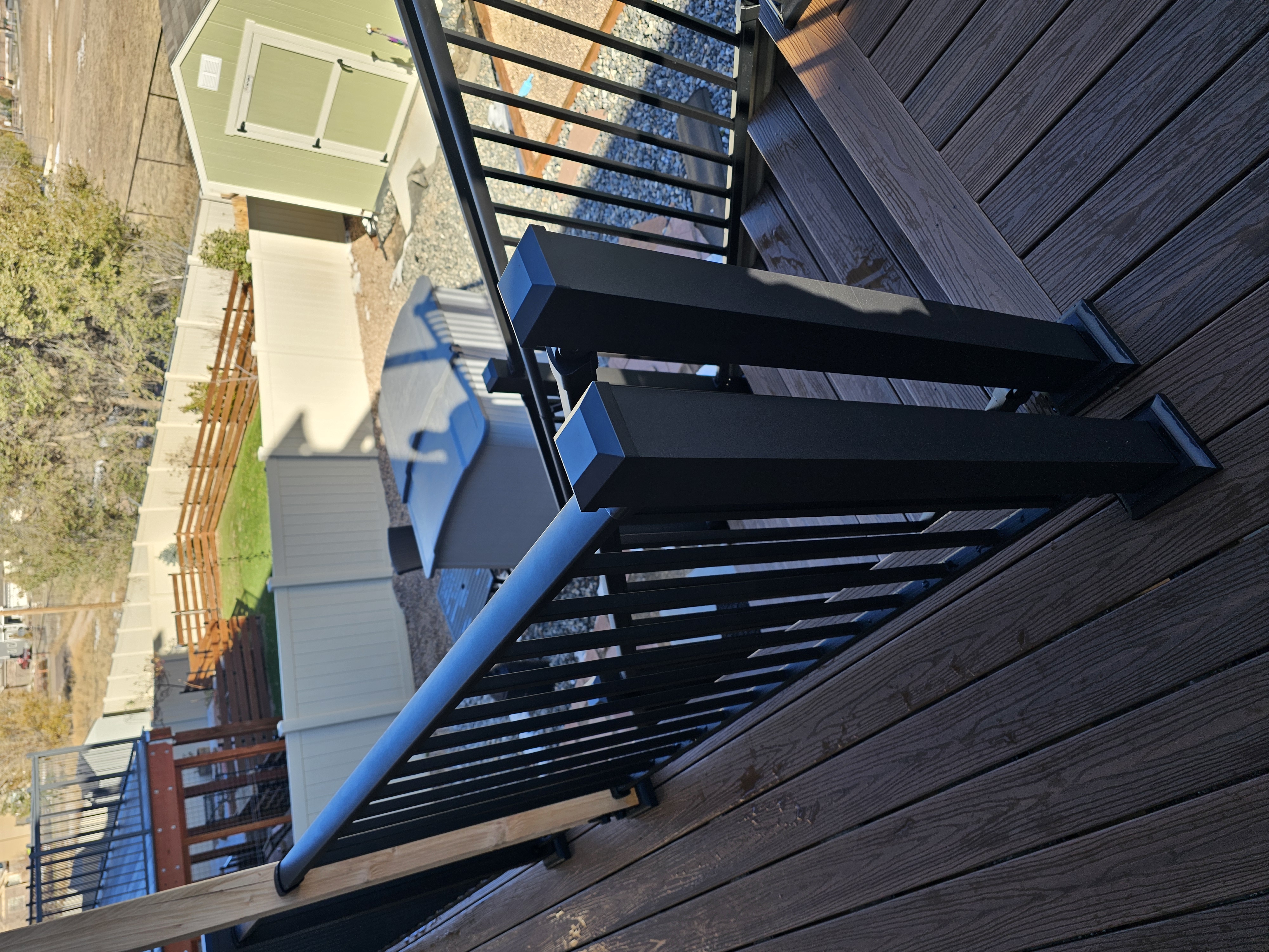 Walk-out deck with stairs to a landscaped yard