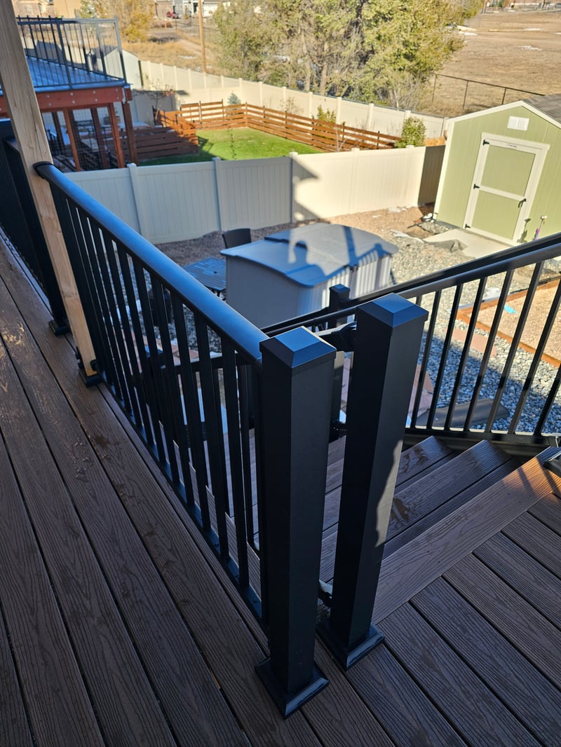 Walk-out deck with stairs to a landscaped yard