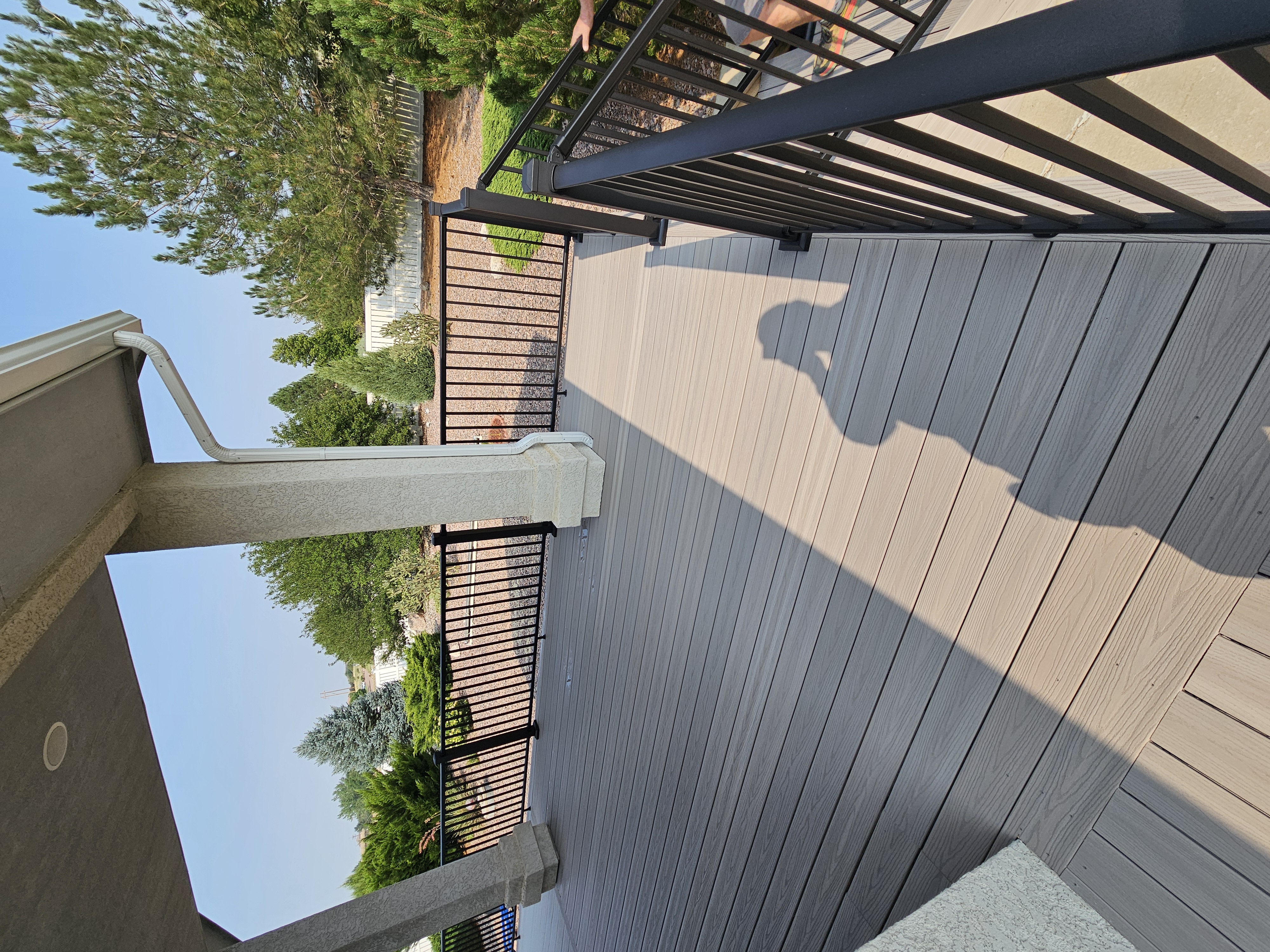 Stained wood deck with post-cap lighting at dusk