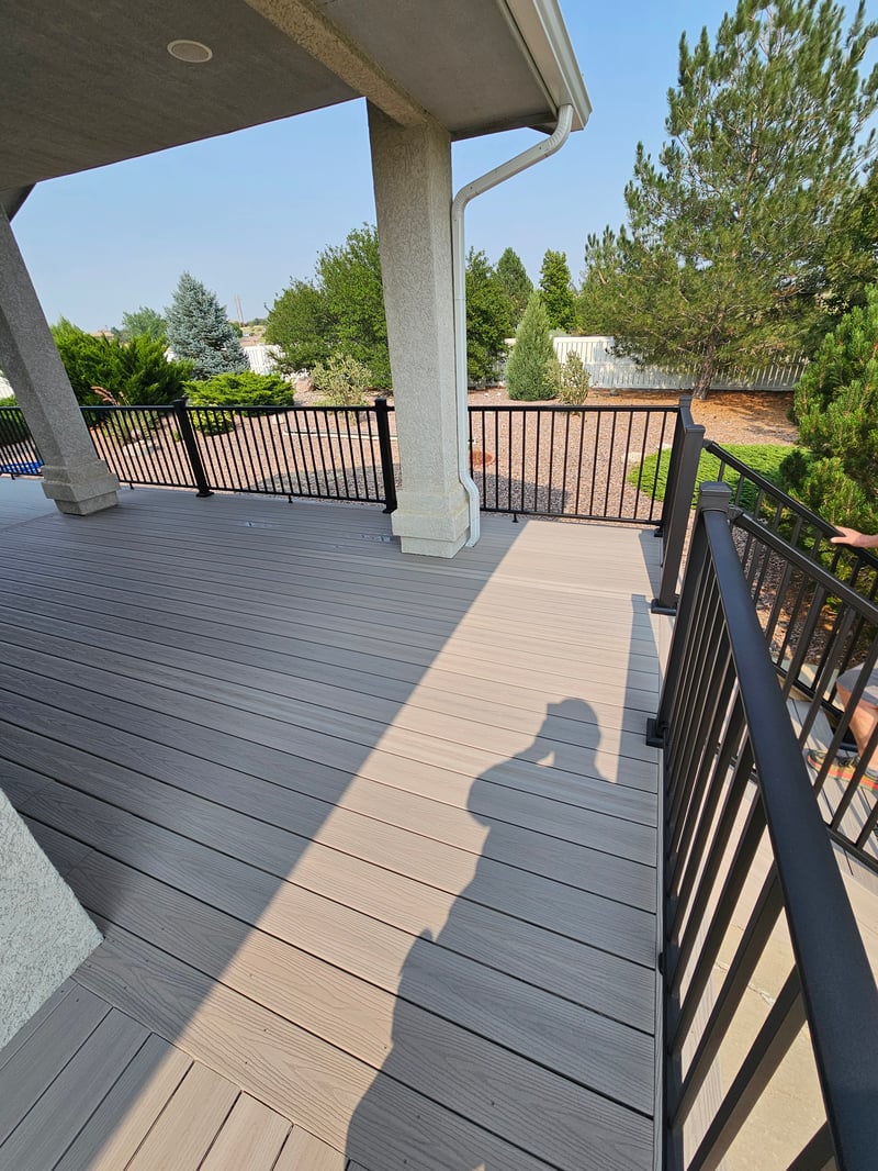 Stained wood deck with post-cap lighting at dusk